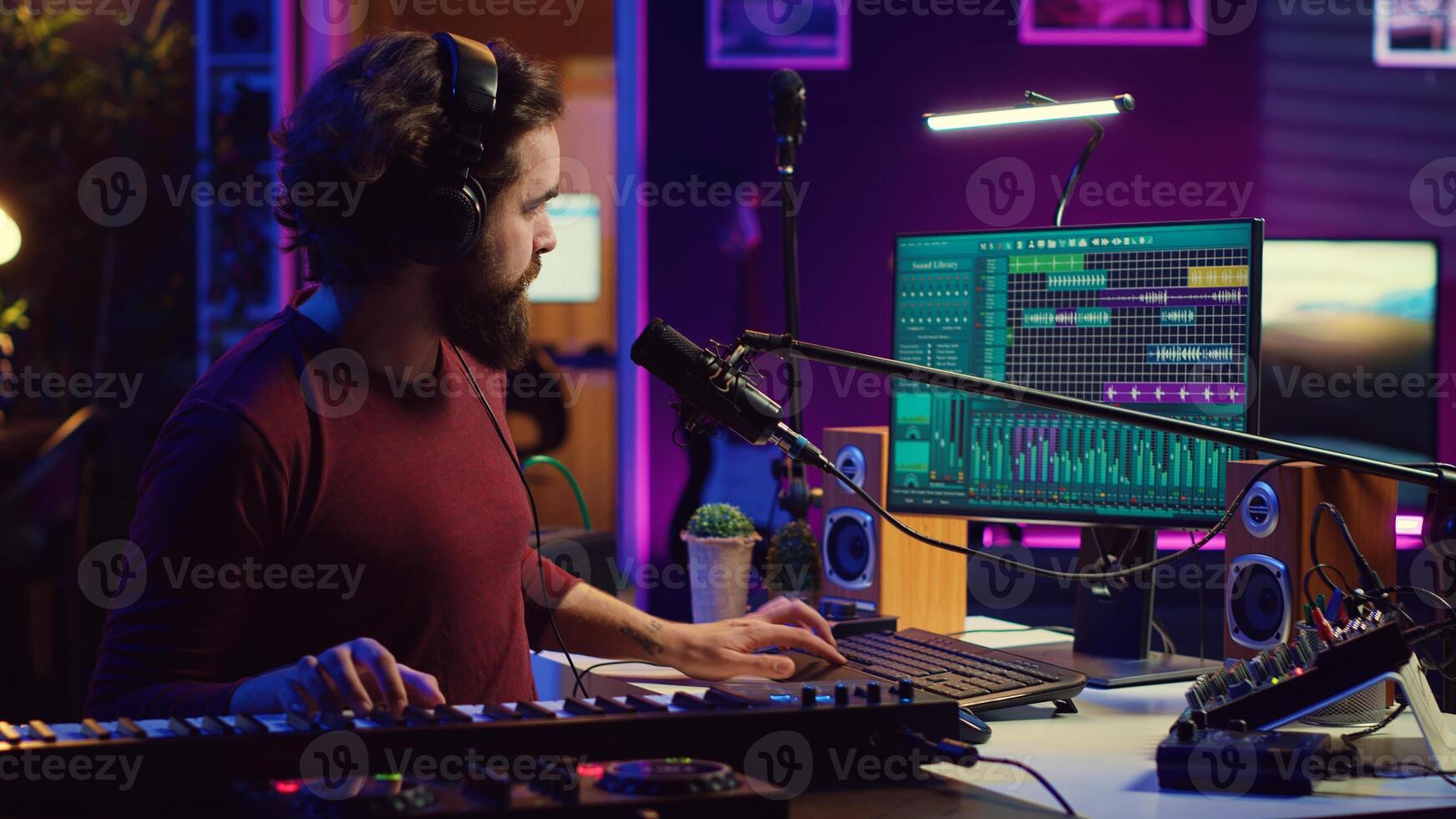Sound engineer pressing keys of electric synthesizer and recording new music, adjusting noise level. Artist singing song on microphone, works with mixing board in home studio. Camera A. photo