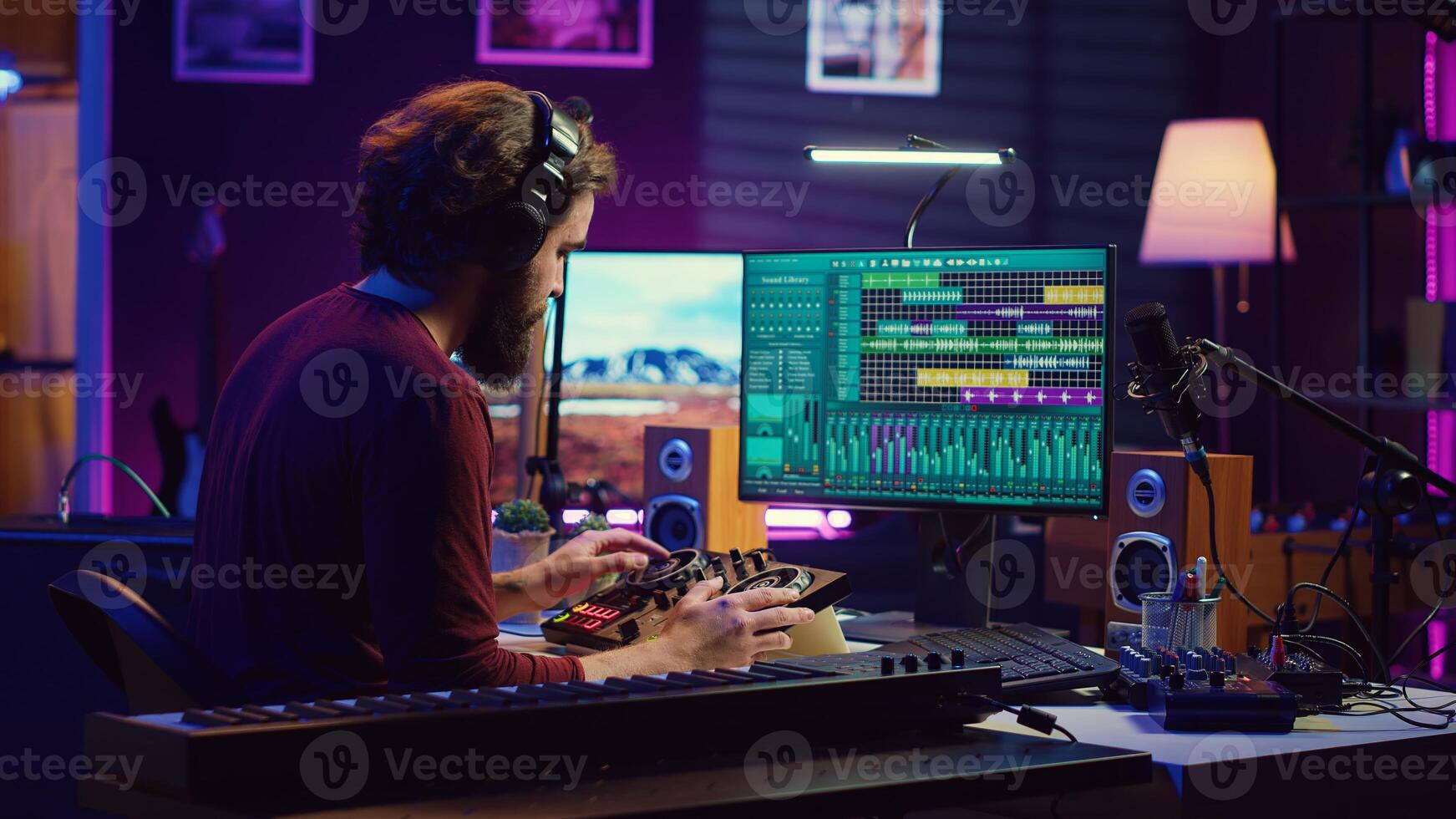 Music engineer operates recording equipment in home studio, working with mixing consoles and digital audio workstations to create sound effects on soundtracks. Production techniques. Camera A. photo