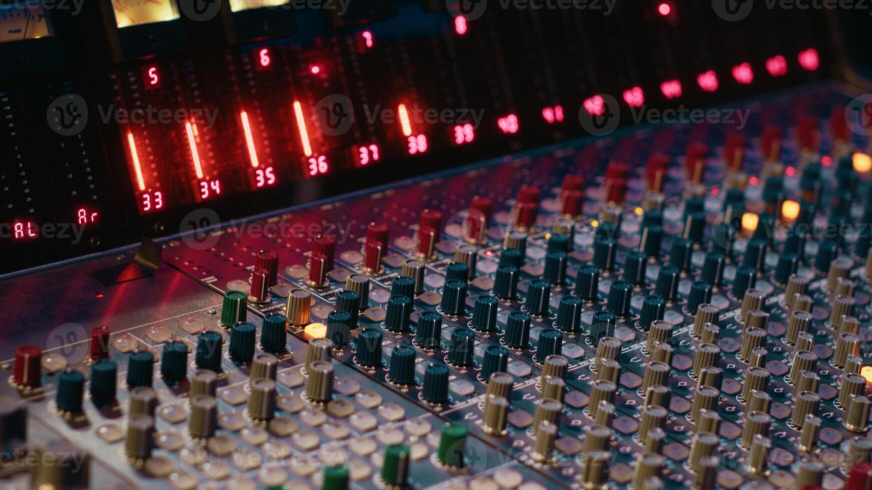Control room panel board with buttons and switchers serve as mechanical and technical equipment of recording and mixing sound. Empty professional soundproof music studio. photo