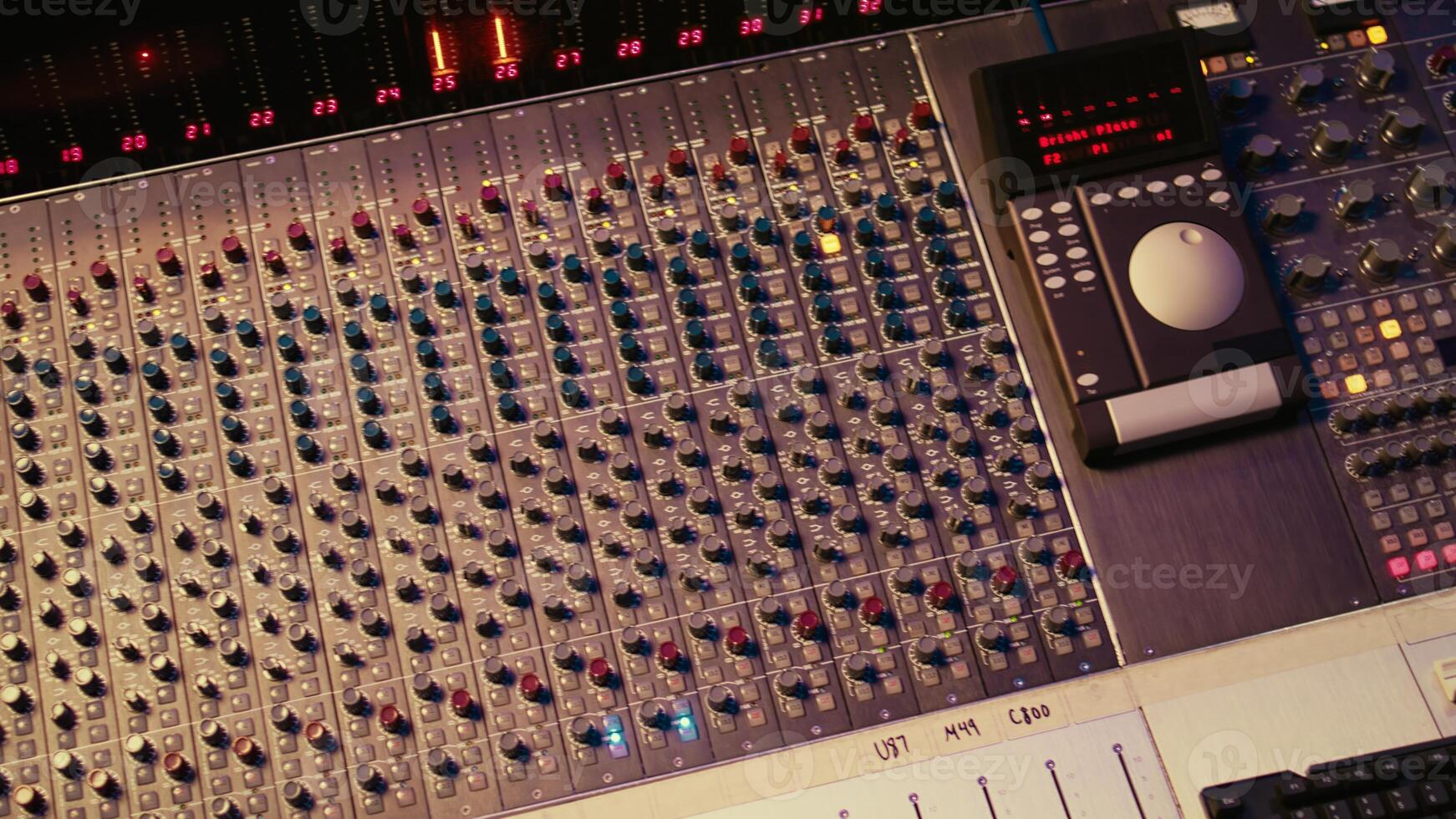 Empty professional recording studio with audio software on pc and control desk buttons or sliders. Technical equipment used to mix and master tracks, editing in post production. photo