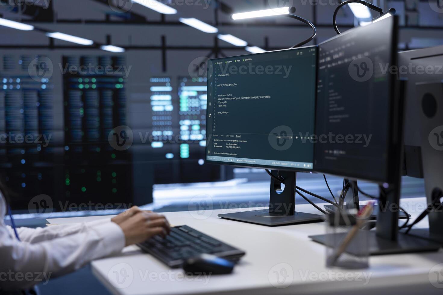 Close up shot of system administrator in data center typing on keyboard, working on computer to do checkup on hardware. IT expert inputting data on PC in server farm after finishing maintenance photo