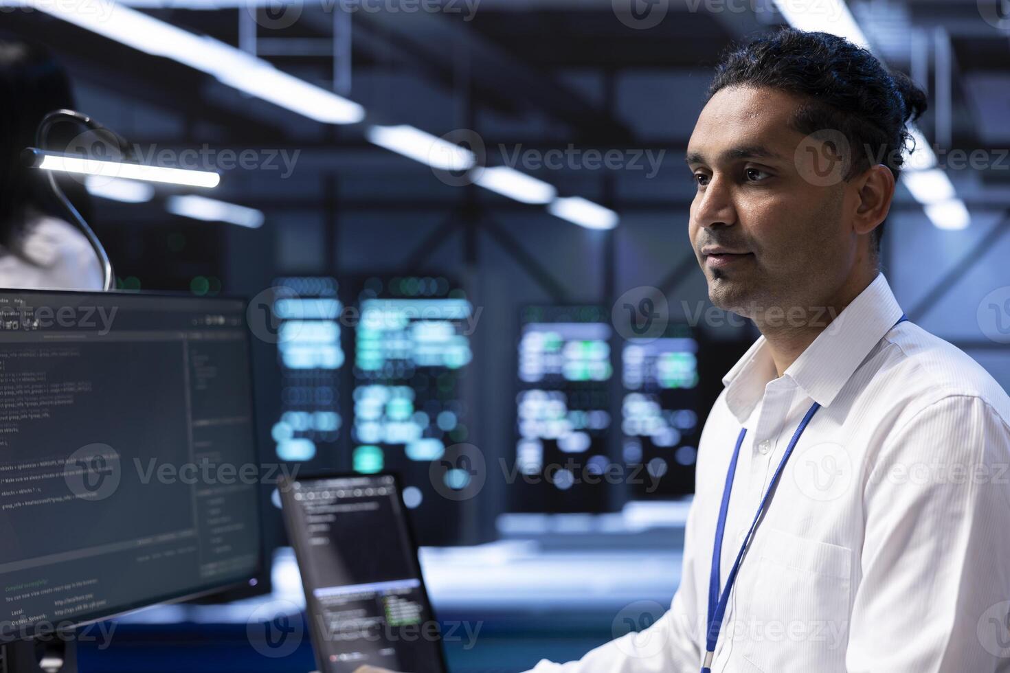Technician in high tech facility housing supercomputers, storage devices and networking parts providing vast amounts of computing resources. Specialist doing server racks maintenance photo