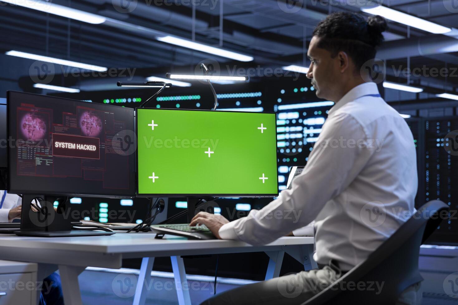 Engineer in server hub using green screen PC to stop hacker passing company firewall and stealing sensitive user data. Worker looking at mockup computer display, seeing security breach notification photo