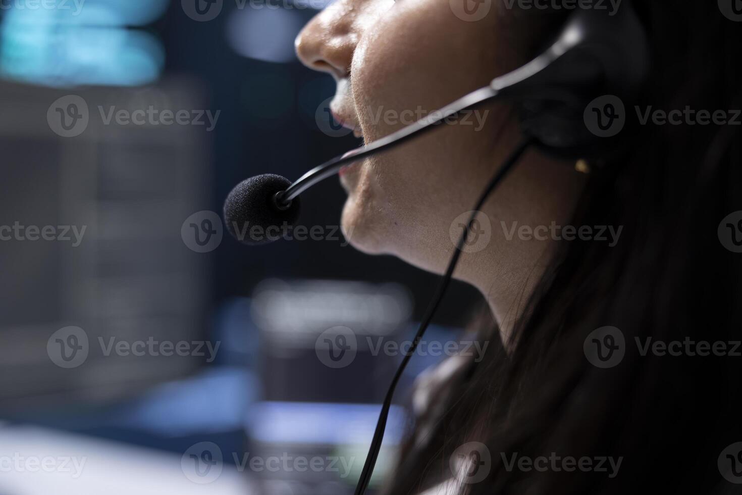 Data center support specialist supporting engineering team doing hardware maintenance, talking in headset microphone. Close up of employee in server hub coordinating technicians using mic photo