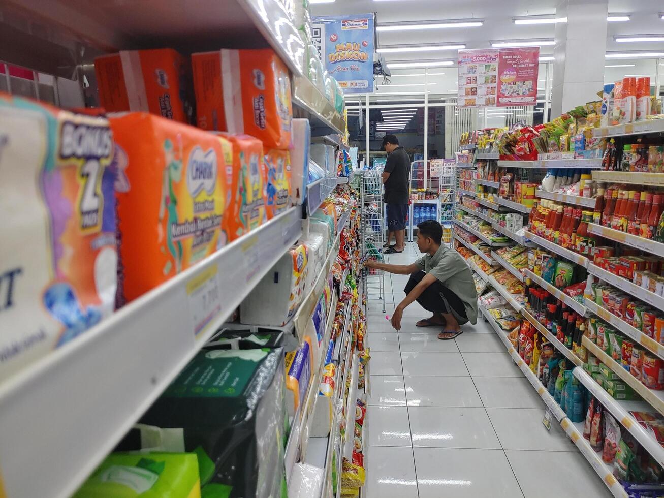 Lombok, Indonesia, February 12, 2024 - Close-up view of an Indonesian minimarket selling retail products photo