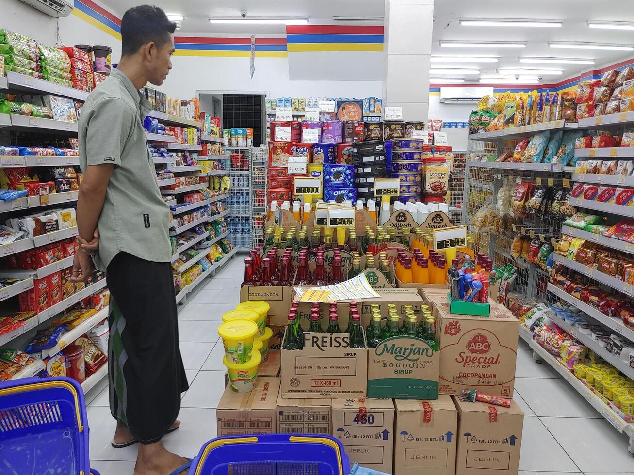 Lombok, Indonesia, February 12, 2024 - Customers are looking at products in an Indonesian minimarket store photo