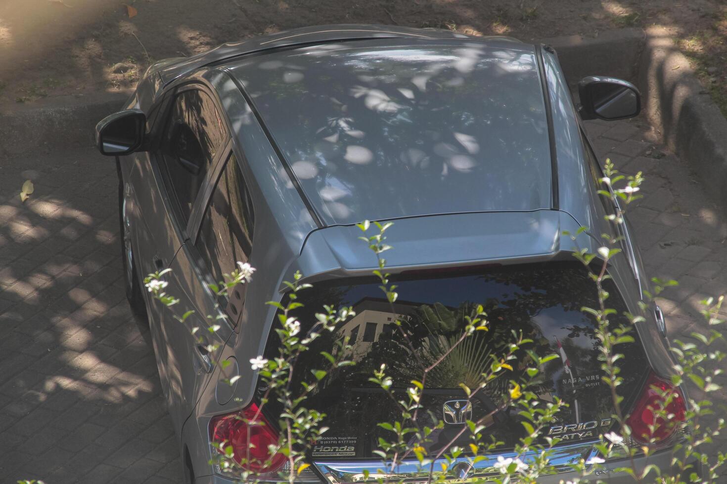 Mataram, Indonesia, May 25 2024 - car parked in the front yard of the campus, top view photo