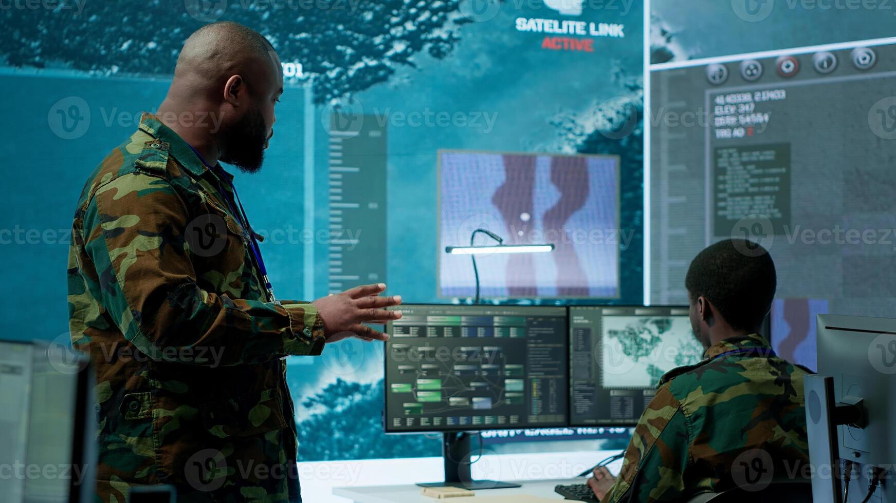 Military staff work in a high tech monitoring room command post, managing cybersecurity operations and surveillance systems. Soldier ensures data protection for national safety. Camera A. photo