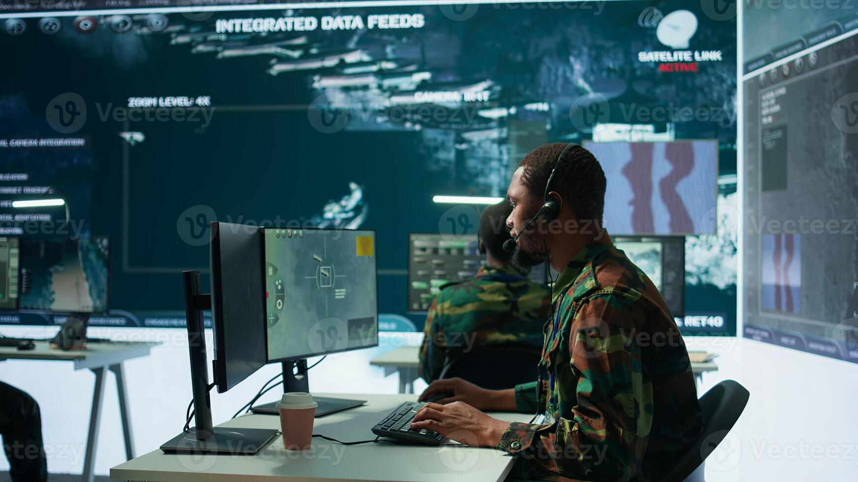 Army intelligence specialist utilize advanced computer systems, surveillance technology and data to enhance national security. Working in a command post against potential threats. Camera B. photo