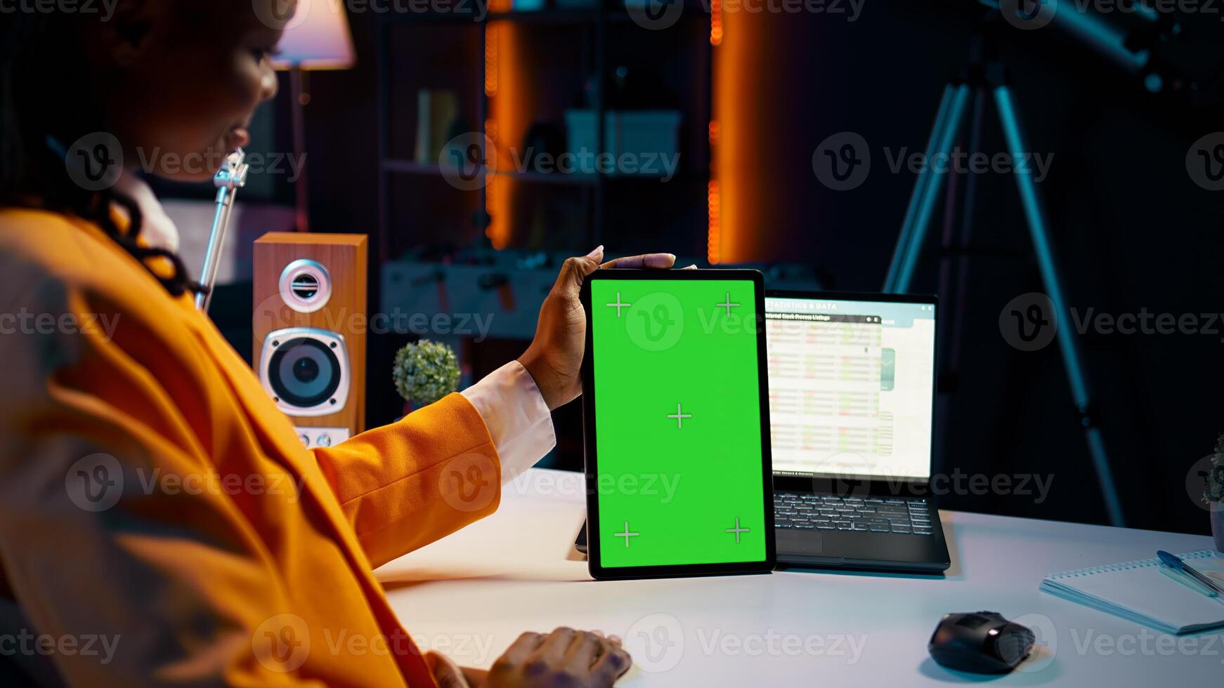 African american girl holding tablet with greenscreen layout, conducting data analysis for financial or economics courses. Student uses isolated mockup display on device, work from home. Camera B. photo