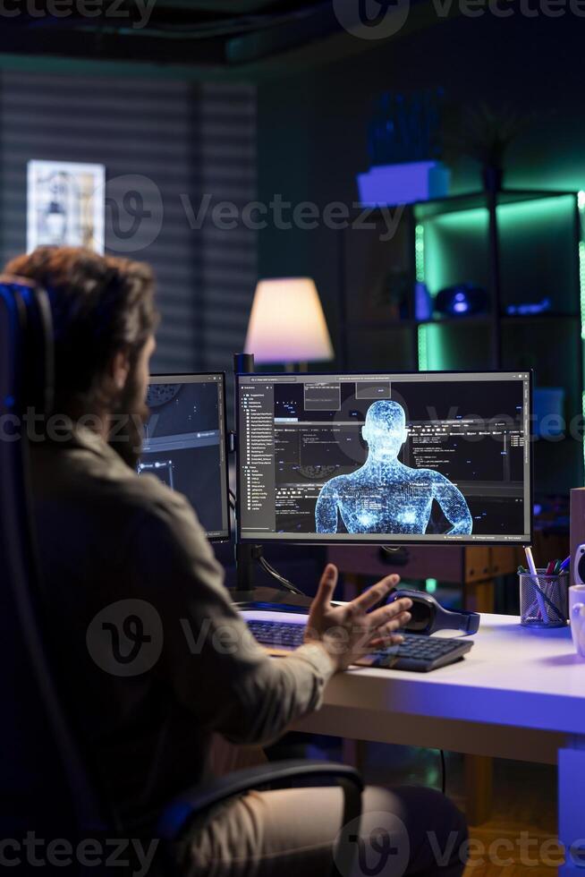 Admin confused by AI gaining consciousness, using humanoid form to interact with creator. Computer technician astonished by artificial intelligence becoming sentient and appearing on monitor photo