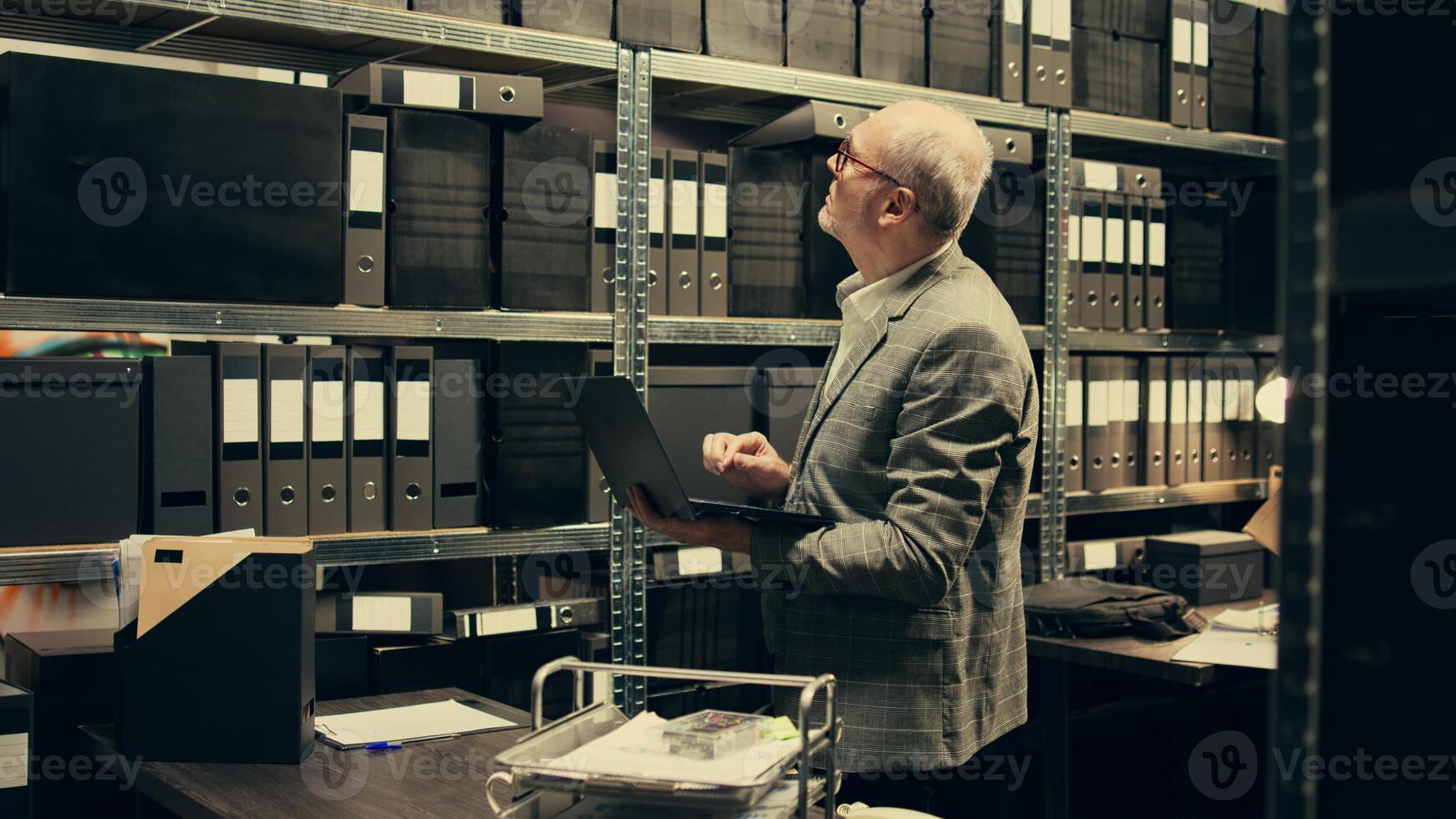 Private investigator reading legal documents and federal notes in archive room, working on criminal case. Law enforcement agent opening investigation to find a suspect, bureaucracy. Camera A. photo