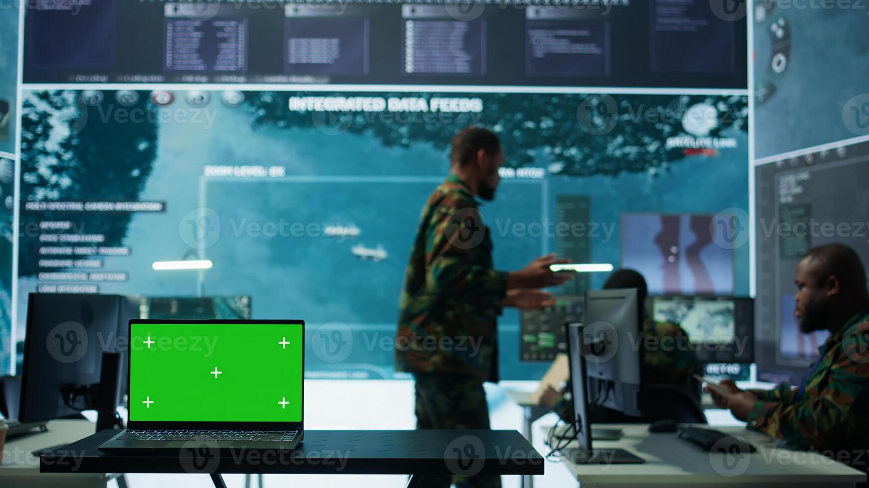 Military IT specialist in command center working on collecting field data, process real time surveillance footage and imagery for successful defense operation. Isolated mockup display on pc. Camera B. photo