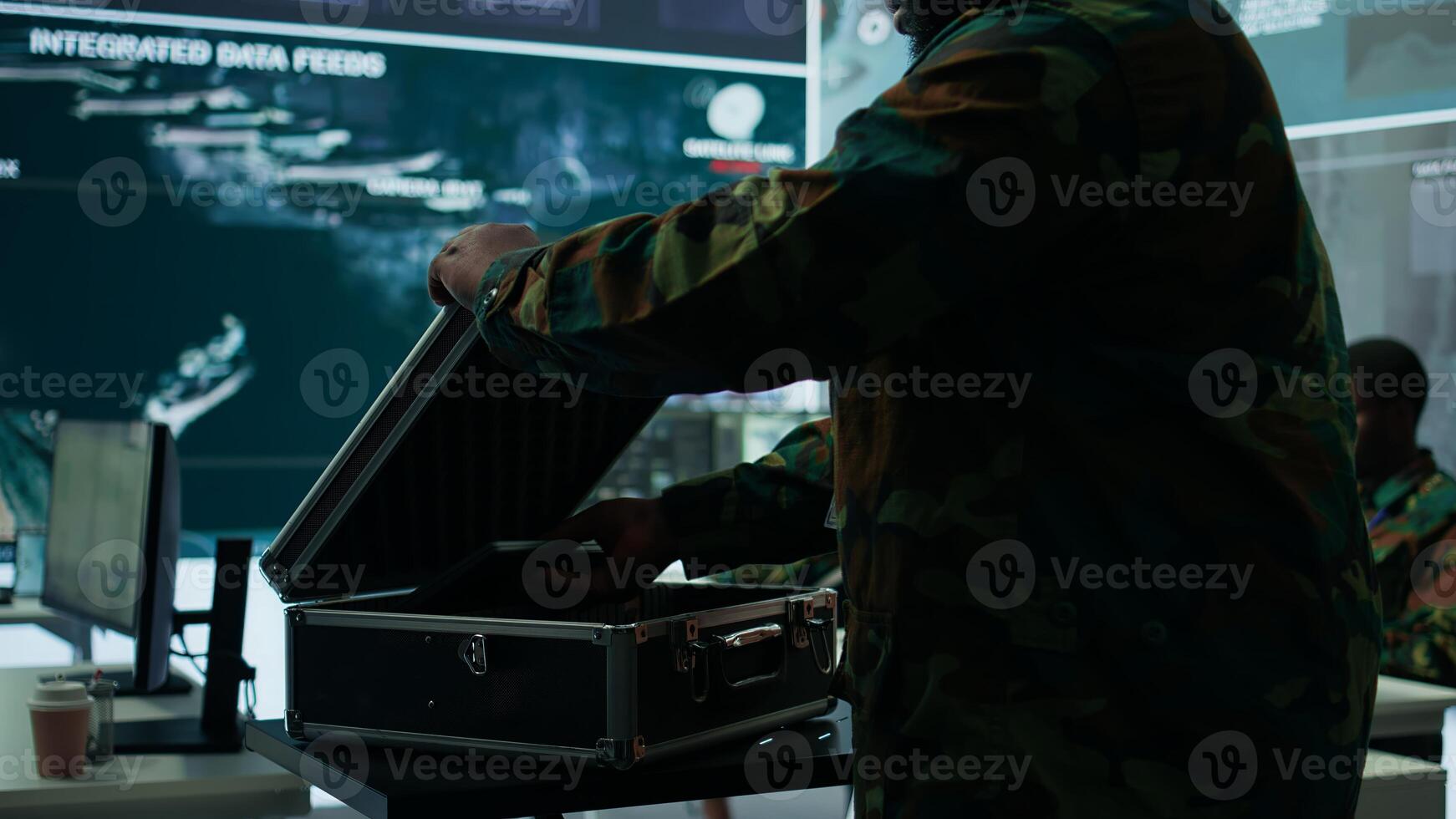 Government intelligence expert works on laptop in a command center to manage surveillance operations, collecting real time data for security measures. Protecting national interests for efficiency. Camera B. photo
