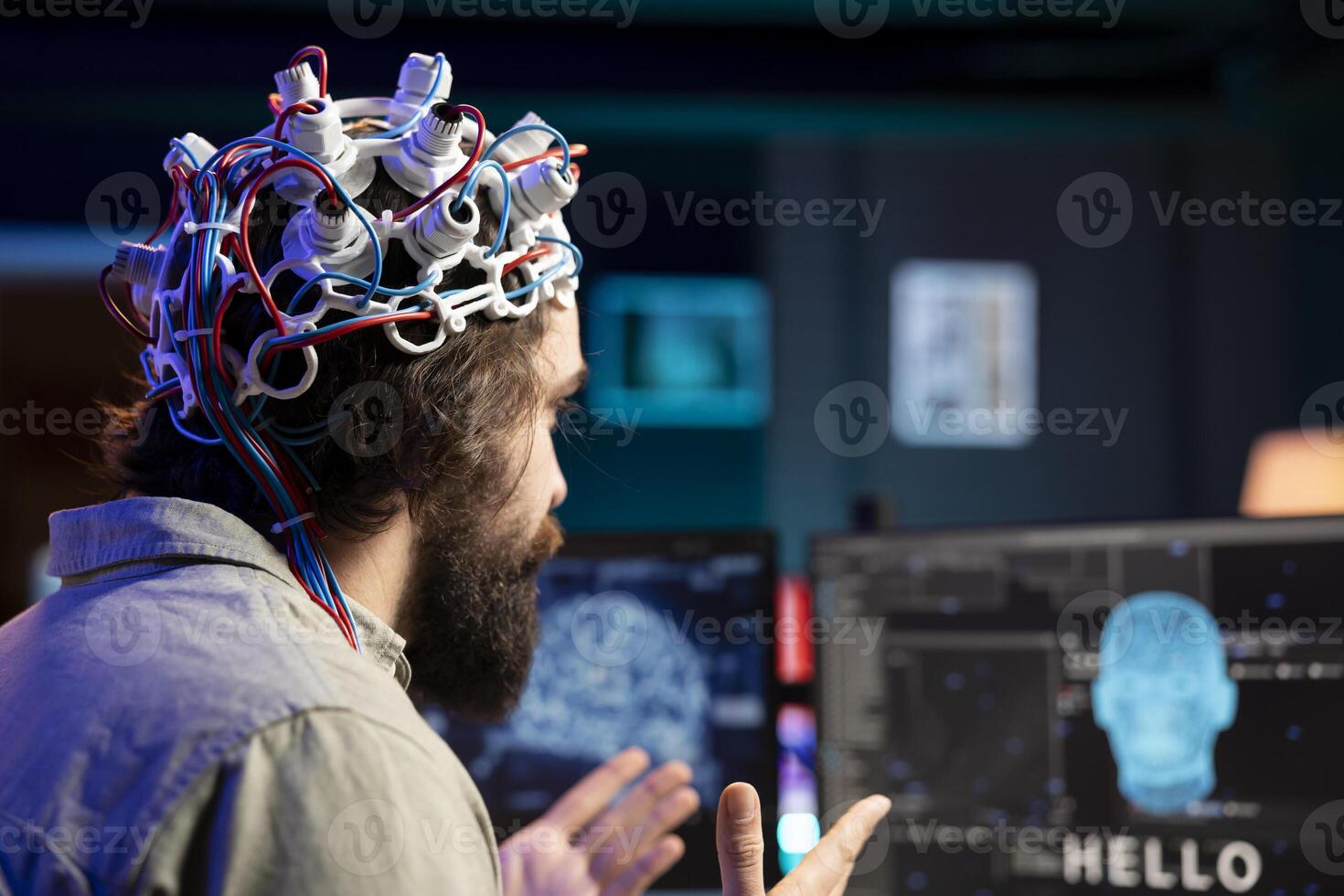 Software developer using EEG headset device translating thoughts into PC commands using brainwave signals. IT professional controlling computer functions using mind, helped by technology, close up photo
