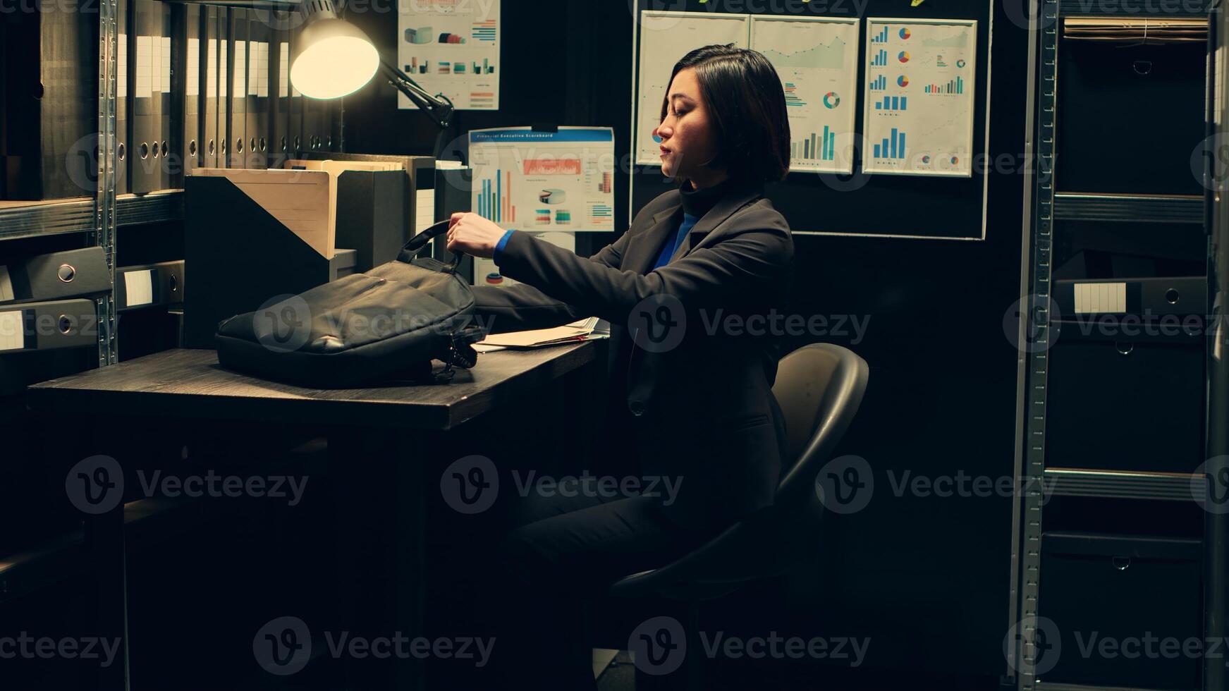 Private detective gathering necessary information from files records in incident room, leaving for field work to follow potential lead. Law agent examines forensic evidence in archive. Camera A. photo