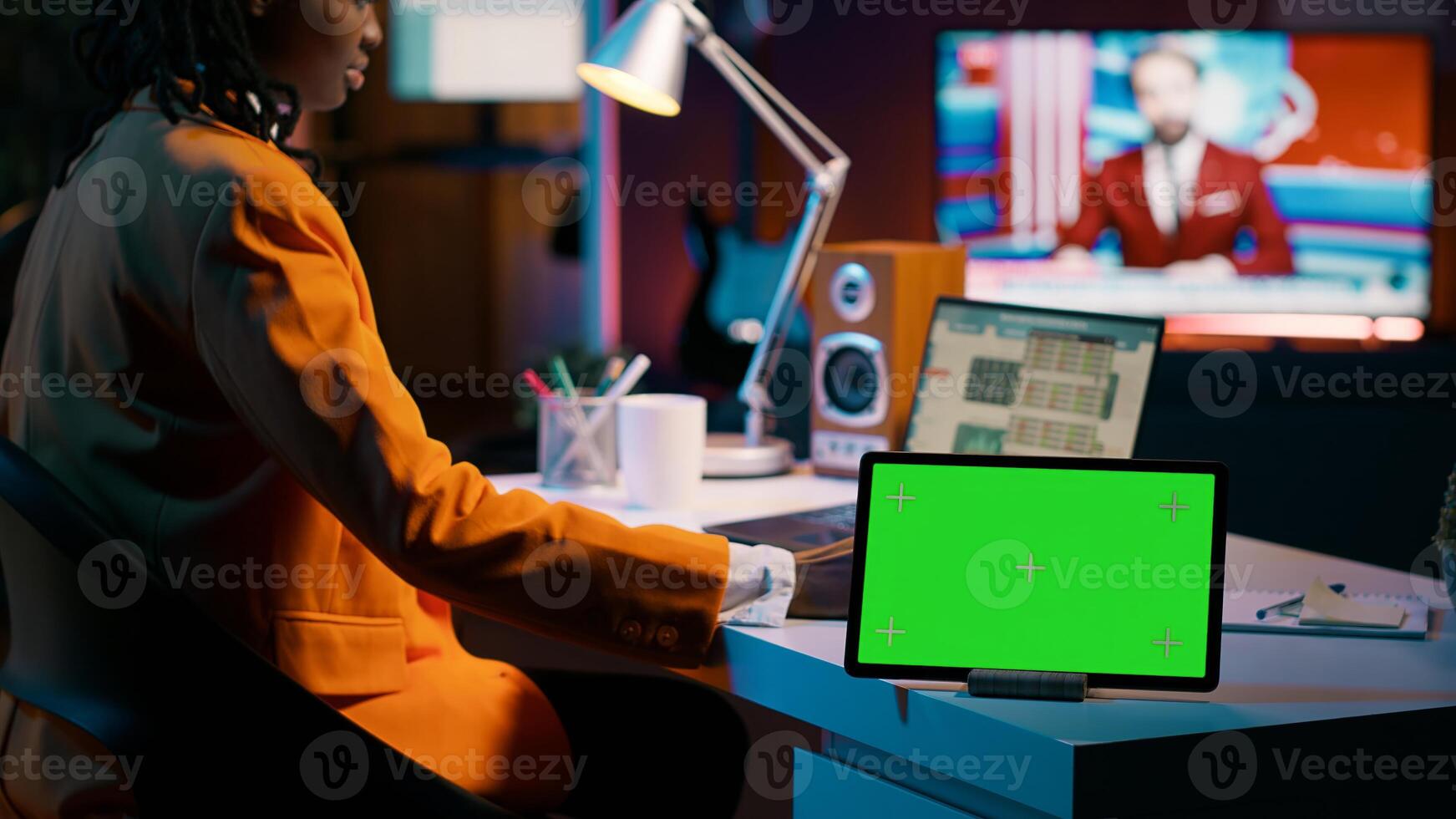 African american pupil looks at greenscreen display on tablet, learning to calculate cost and opportunity. Young woman working on financial software for economics classes. Camera A. photo