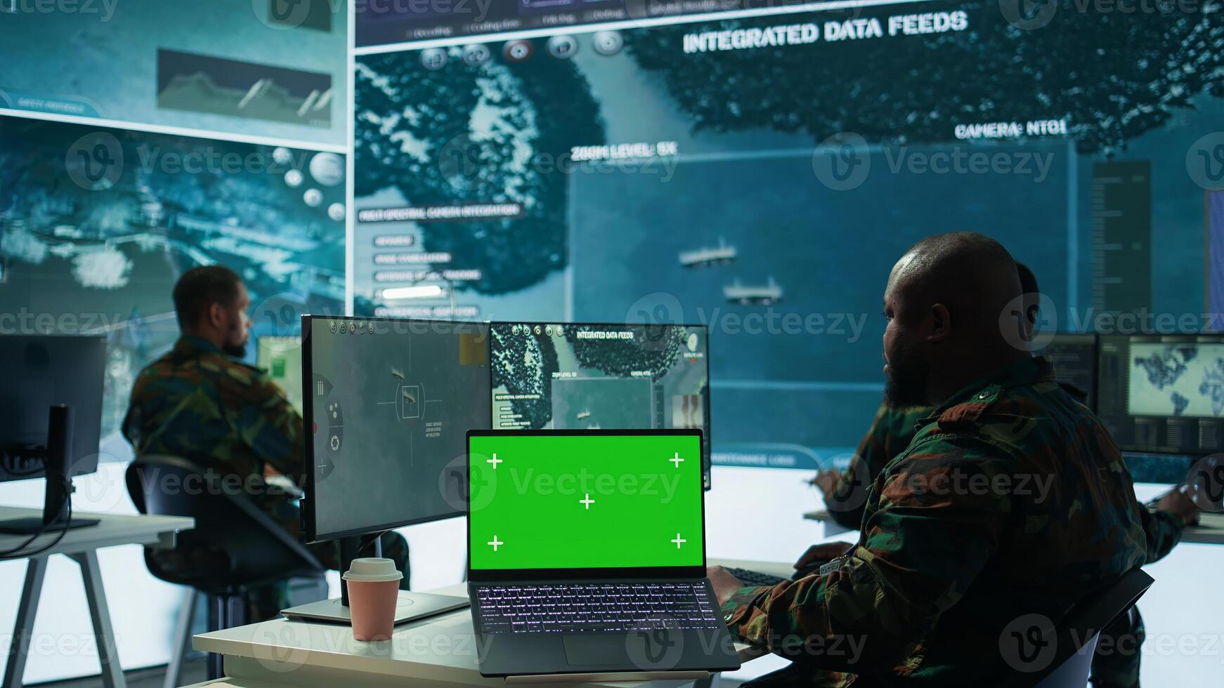 IT expert collecting real time information next to isolated chroma key screen, high tech gear in command post. Soldier processing intelligence for field operations and strategic missions. Camera B. photo