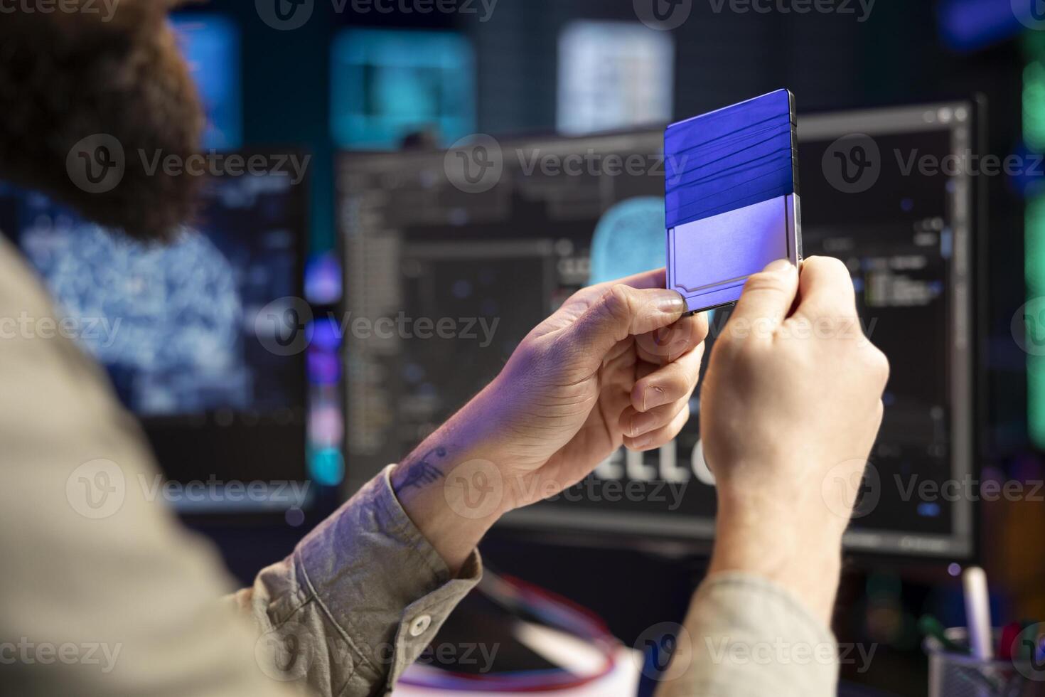 Computer scientist holding disk containing artificial intelligence entity, close up shot. IT professional preparing cartridge to be inserted in desktop PC deploying AI robot on systems photo