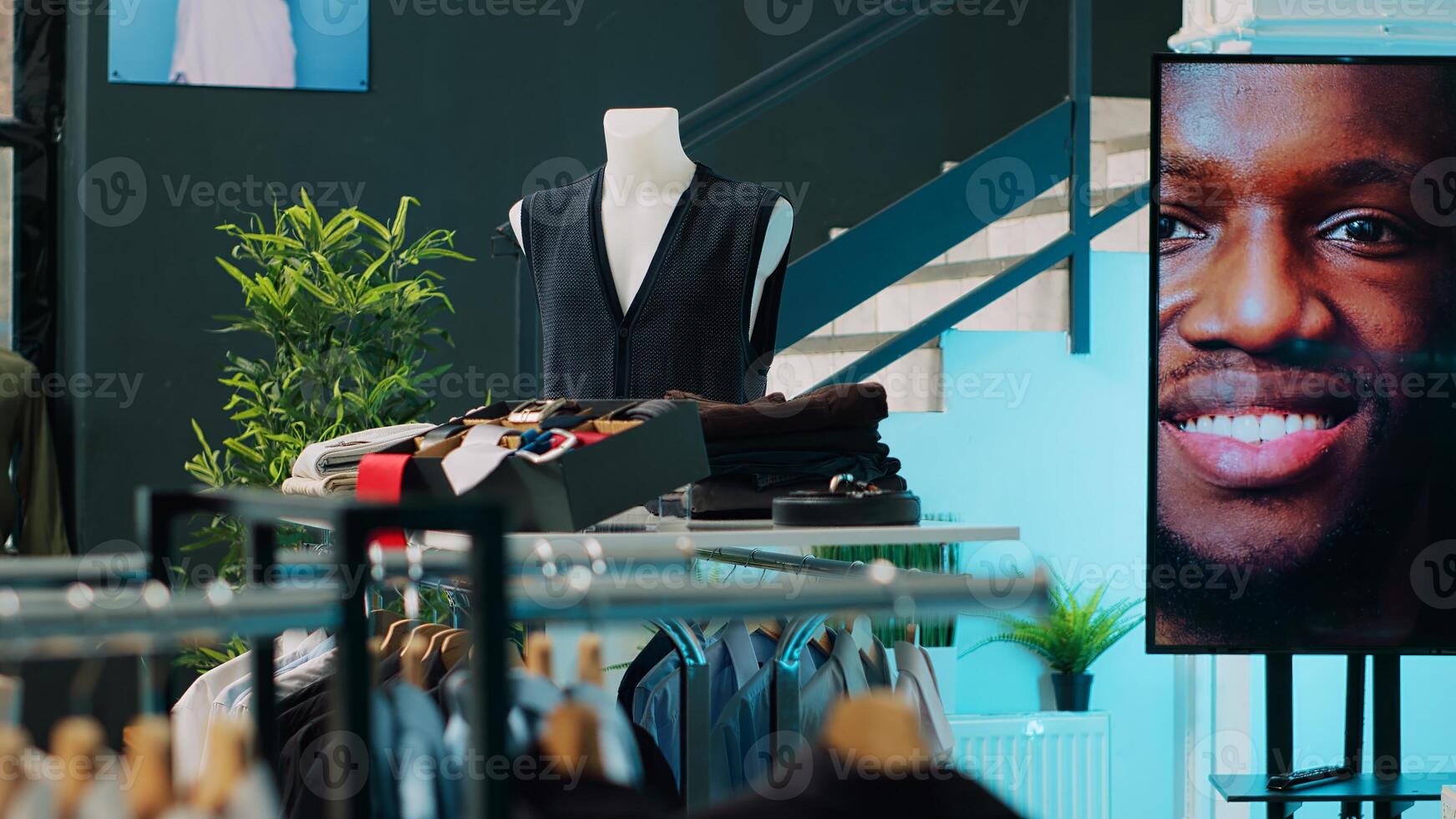 Shopping center having elegant shirts and suits on display, selling fashionable items and accessories. Empty clothing store at mall filled with formal or casual wear, consumerism concept. Camera A. photo