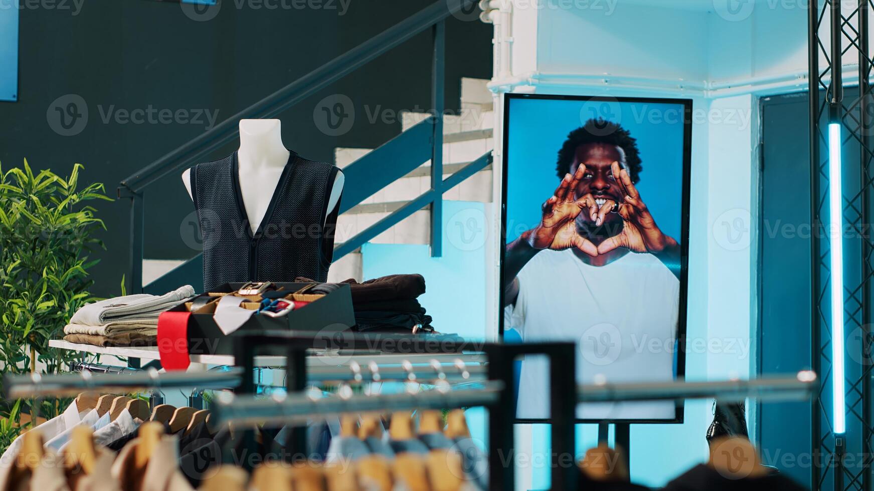 Empty modern clothing store filled with formal wear designs, retail shop with fashion items on hangers and racks. Shopping center boutique with trendy accessories and shoes on display. Camera A. photo