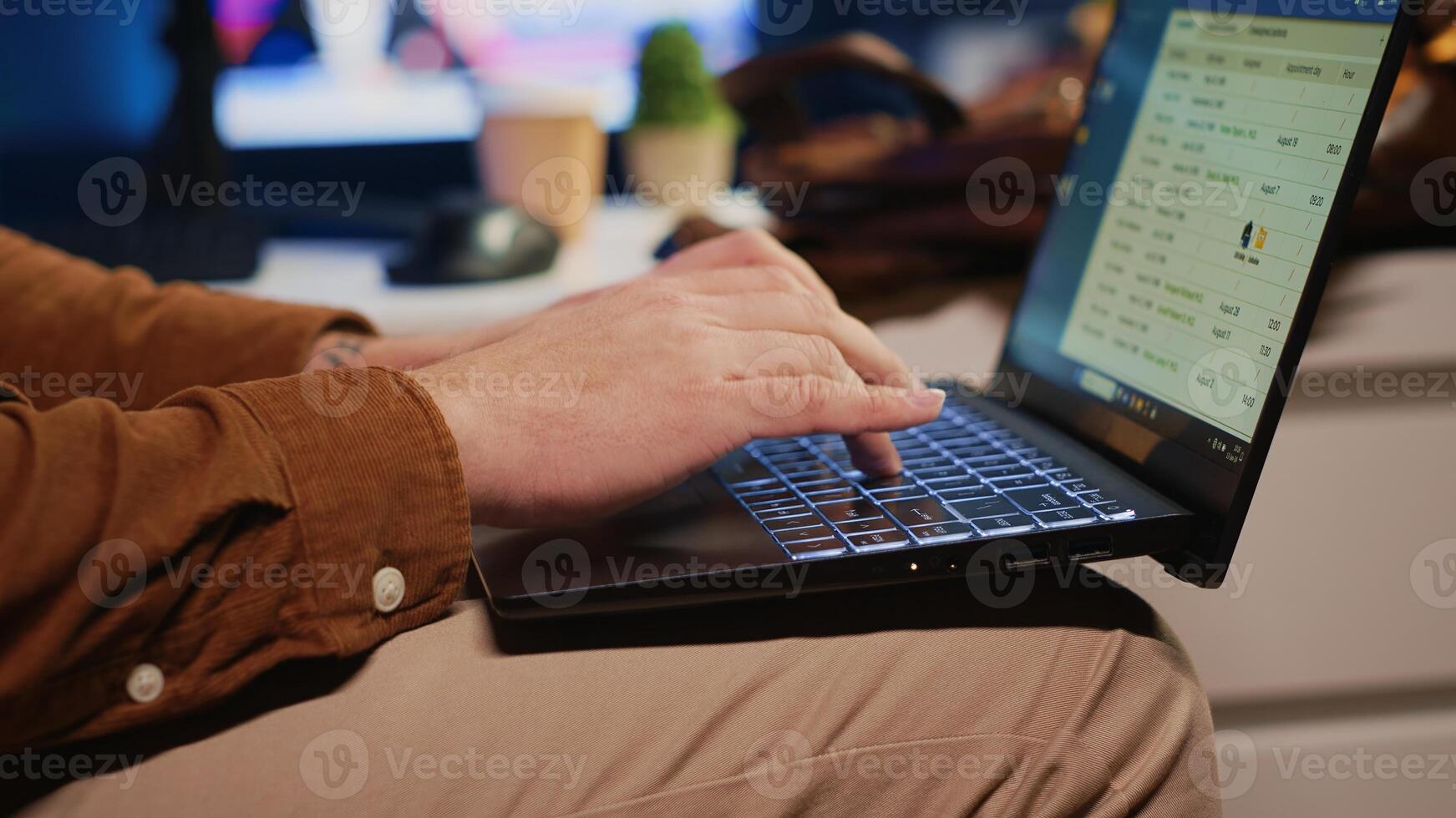 Freelancing computer scientist starting work in personal office at home, taking laptop out of bag. Self employed admin unpacking backpack, writing on notebook keyboard, camera A close up shot photo