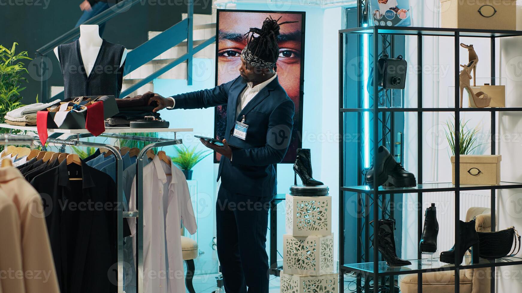 African american employee giving advice to senior customer in retail store, trying to find an elegant shirt on sale. Elderly client asking assistant for suggestions and recommendations. Camera A. photo