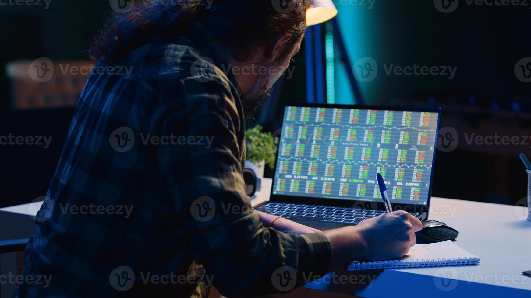 Happy broker investor excited about high stock exchange income after calculating profit using pen and paper. Cheerful freelancer celebrating in apartment after noticing market shares growth, camera A photo