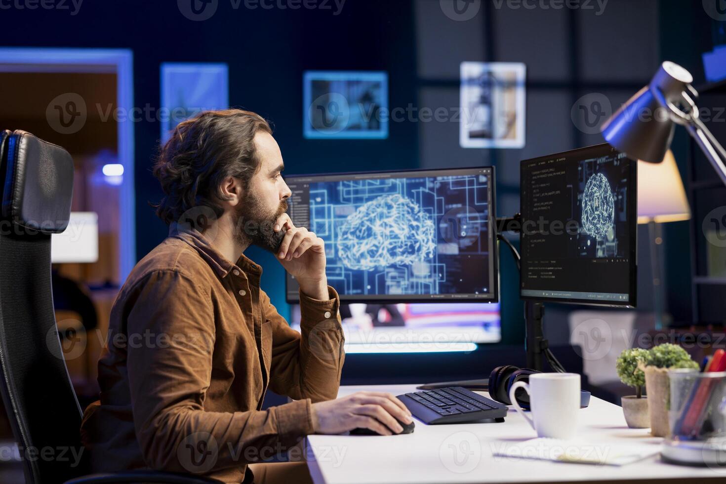 Teleworking programmer using computer for artificial intelligence computing simulating human brain through self learning algorithms. Remote worker working with AI deep neural networks on desktop PC photo