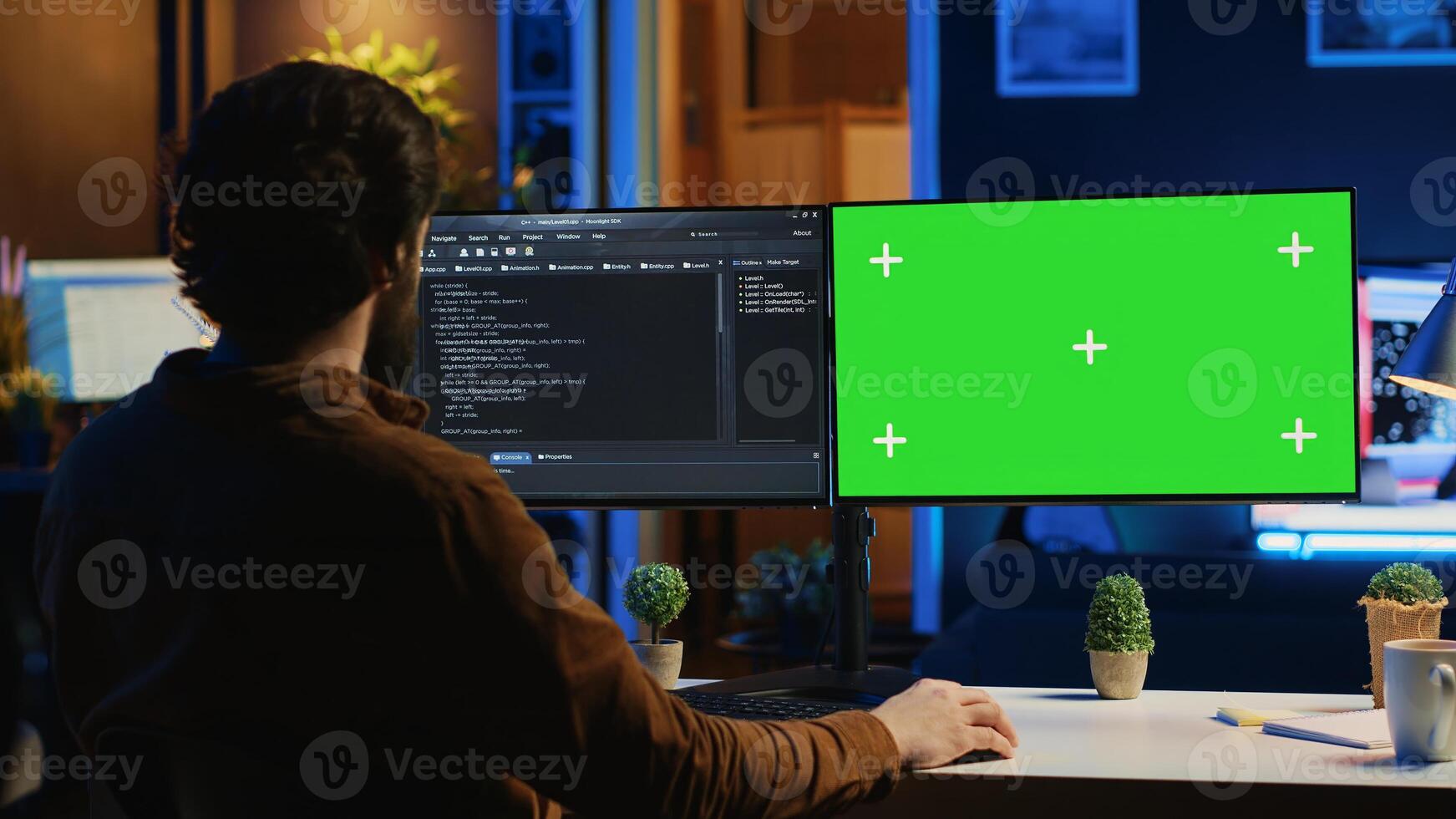 Freelancing man doing IT support job from apartment personal office, coding on isolated screen PC. Software programmer writing lines of code on chroma key computer at home, camera A photo