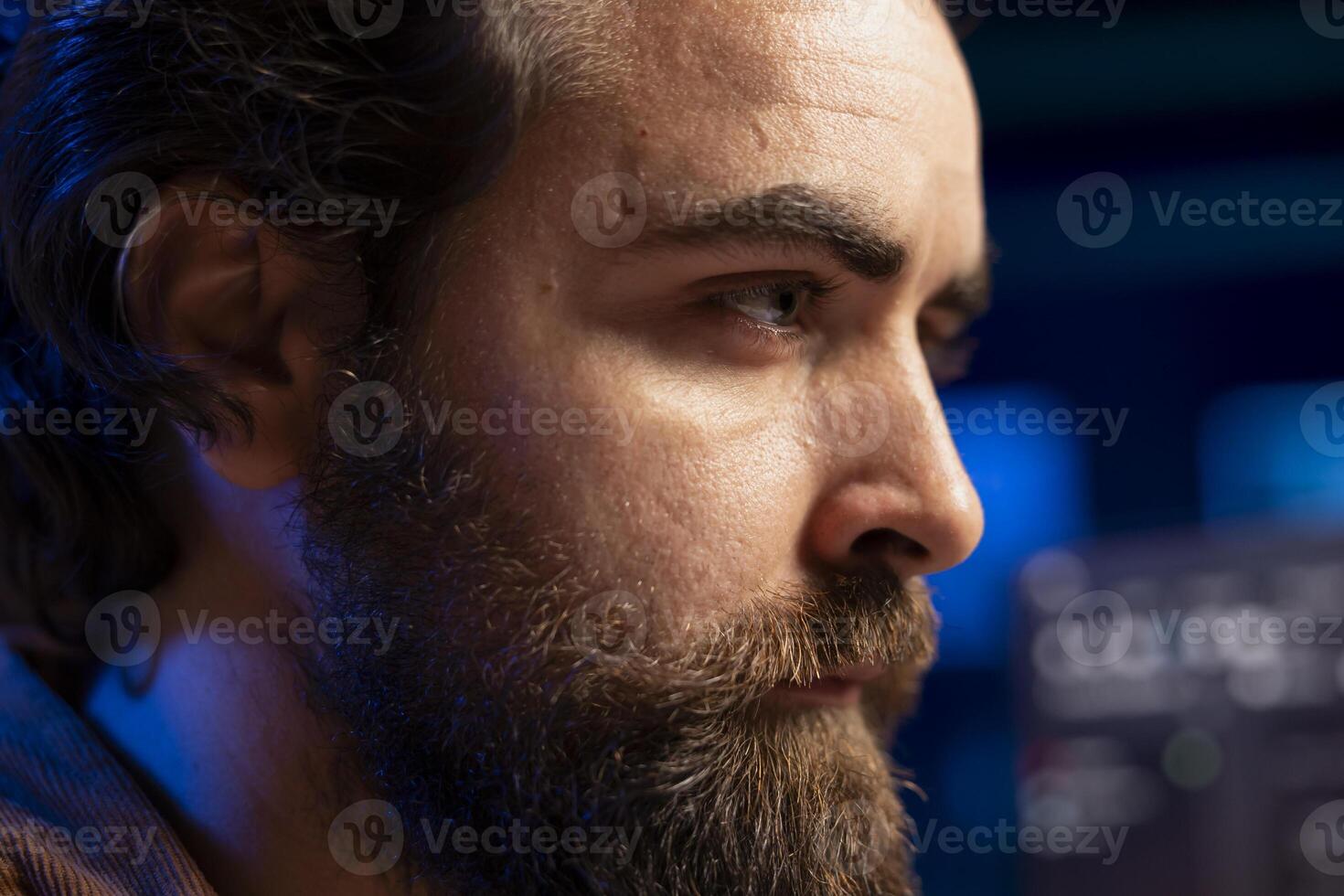 Focus on programmer filtering malicious traffic from cybercriminals attempting to corrupt company data using computer in blurry background, preventing phishing attacks, close up on face photo