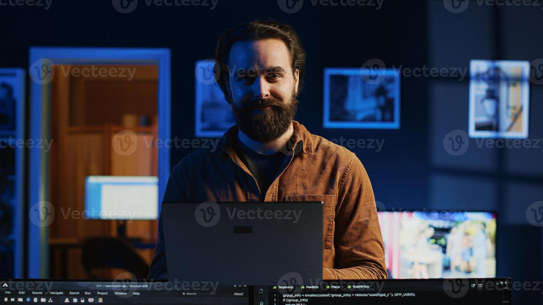 Portrait of smiling developer writing complex binary code scripts on laptop terminal. Cheerful remote IT employee standing in home office, using programming to safeguard consumer data, camera A photo