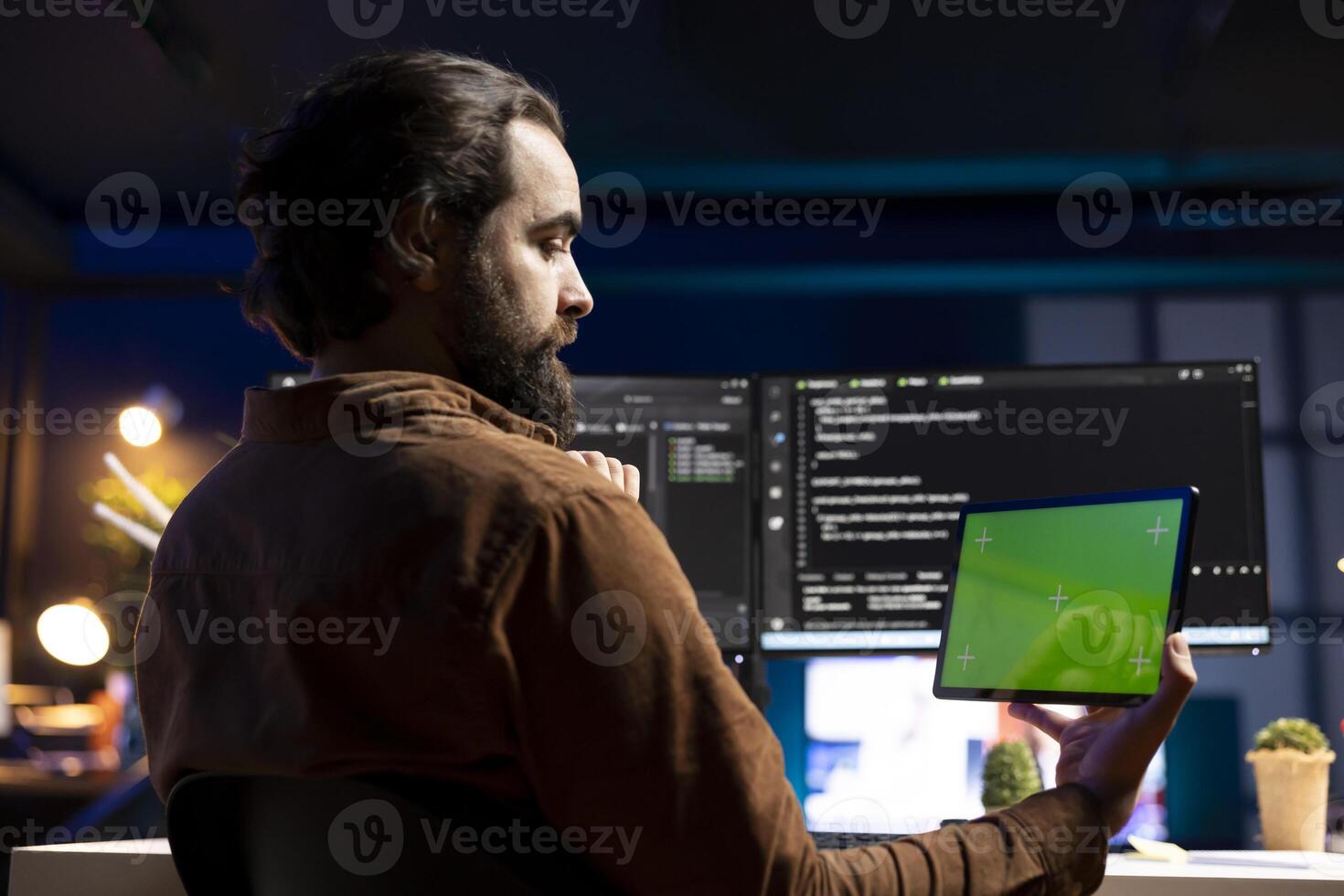 Programmer using green screen tablet to fix vulnerabilities in software. Man taking care of security exposures in operating system, writing code on mockup portable device photo