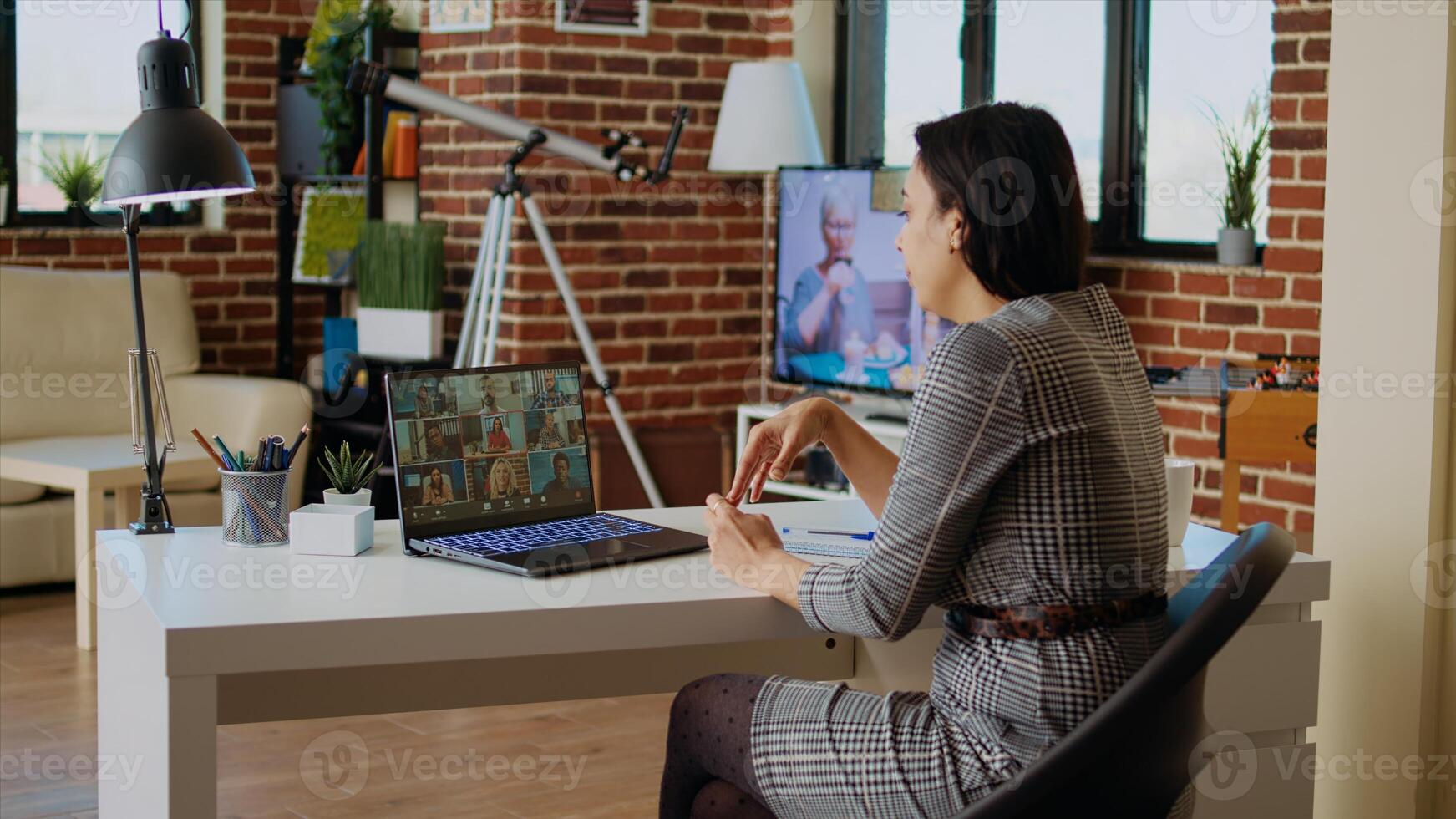 Teleworking management executive in apartment discussing with coworkers during videoconference meeting. Manager holding online videocall with remotely working employees, camera A photo
