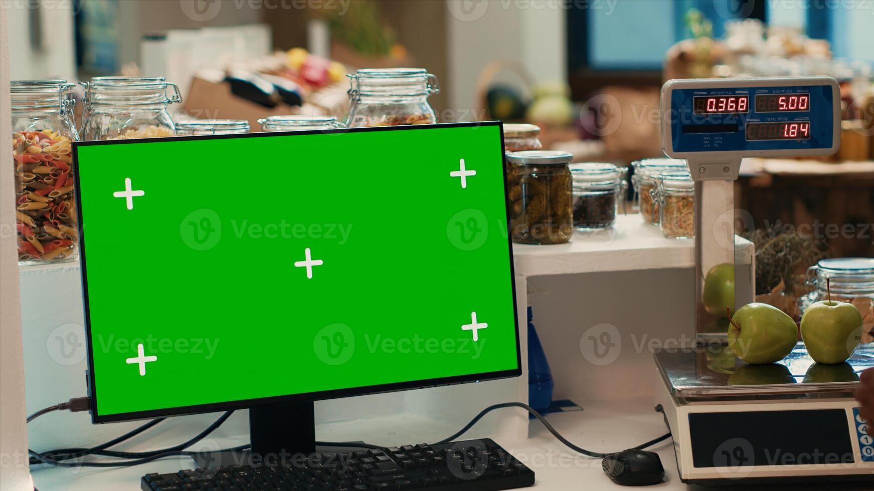 Greenscreen monitor on counter at local bio farmers market, shopper looking for homegrown ethically sourced produce. Blank copyspace chromakey display on computer at supermarket. photo