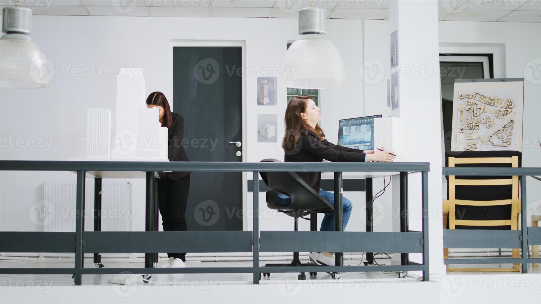Real estate agency employees working on creative blueprints, creating architectural plans and schemes. Women developing designs for residential neighborhood area, construction small business. photo