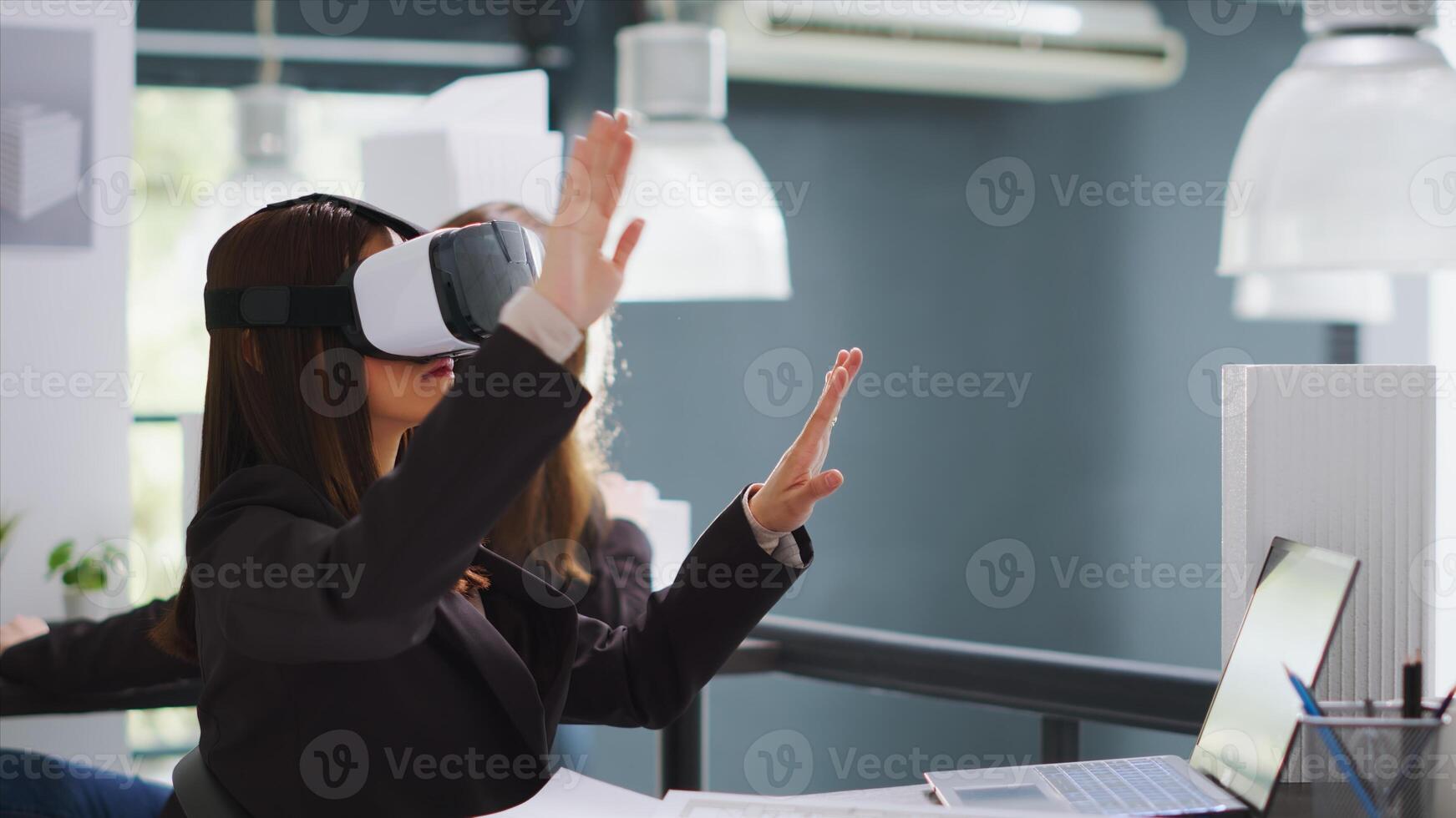 CAD expert working with virtual reality glasses in office, designing metaverse architectural blueprint using artificial intelligence on vr headset. Designer creating drafts and sketches for project. photo