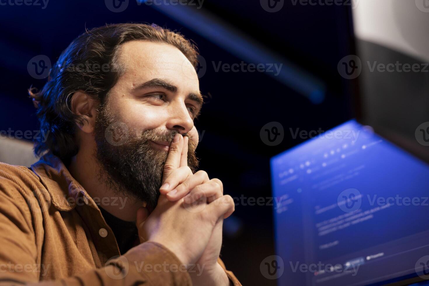 Smiling cybersecurity expert pleased after finding security vulnerabilities and preventing malware infections. Cheerful developer satisfied with installed fortified code preventing cyberattacks photo