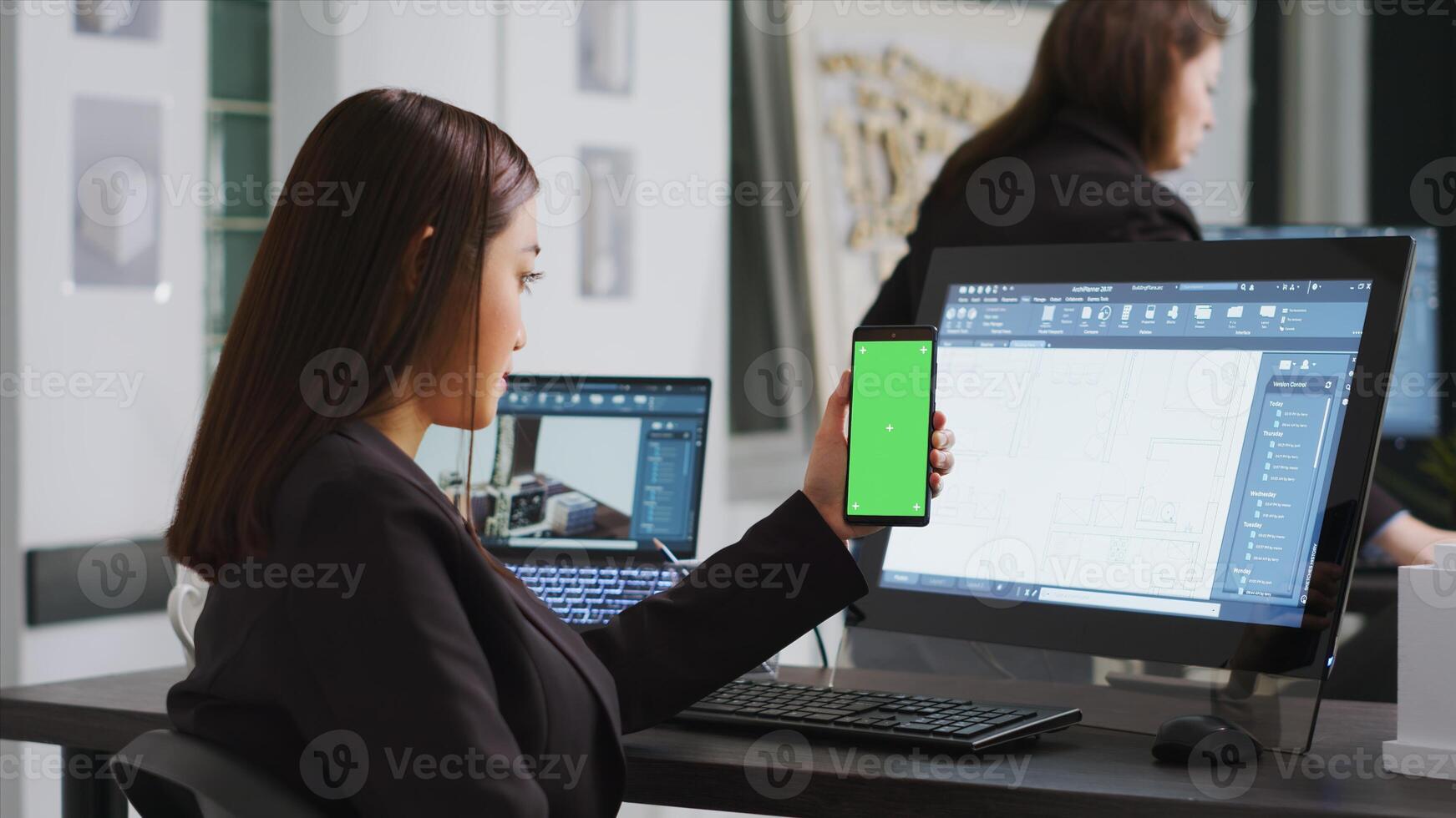 Engineer showing phone with greenscreen template on display, working at a architectural agency office. CAD expert using isolated chromakey layout on copyspace screen, mockup concept. photo