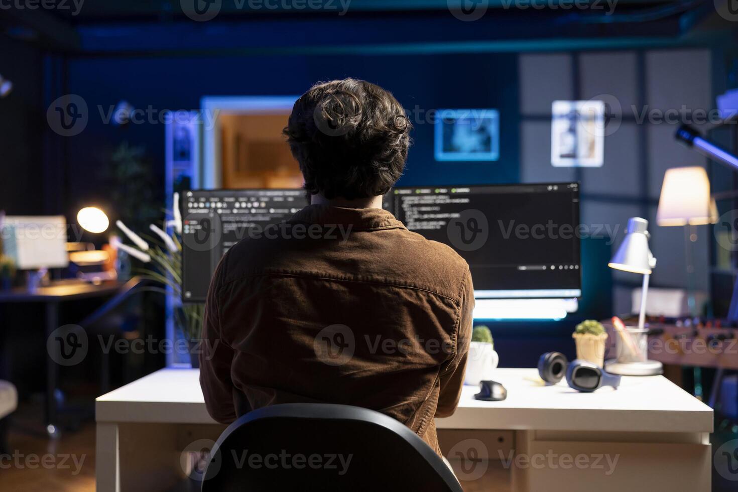 IT specialist working from home developing software in JavaScript programming language using PC. System engineer in apartment writing lines of code on computer using keyboard photo