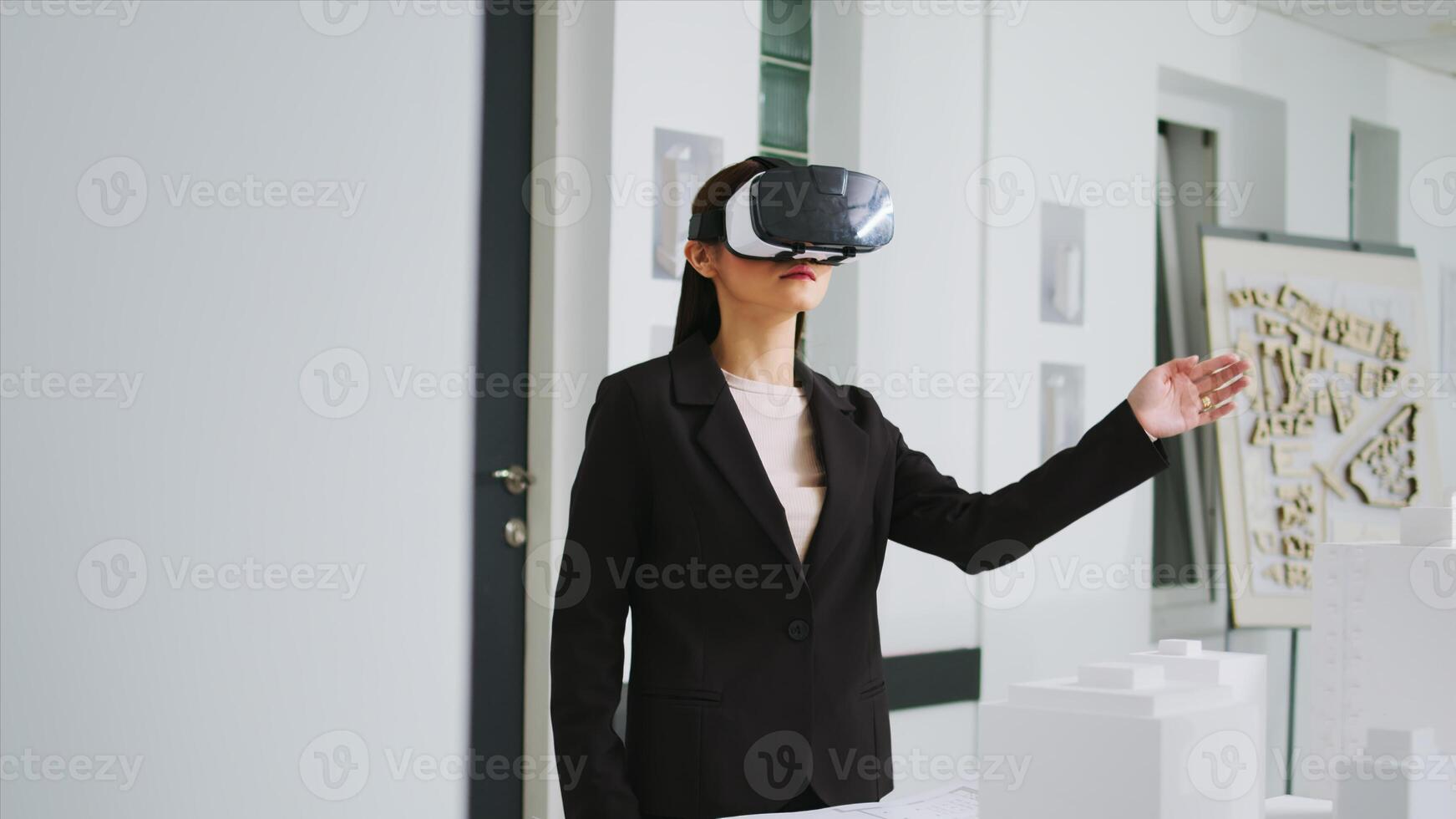 Architect working on new project with vr headset in office, developing industrial plan to remodel building property at unicorn business agency. Woman using virtual reality metaverse tech. photo