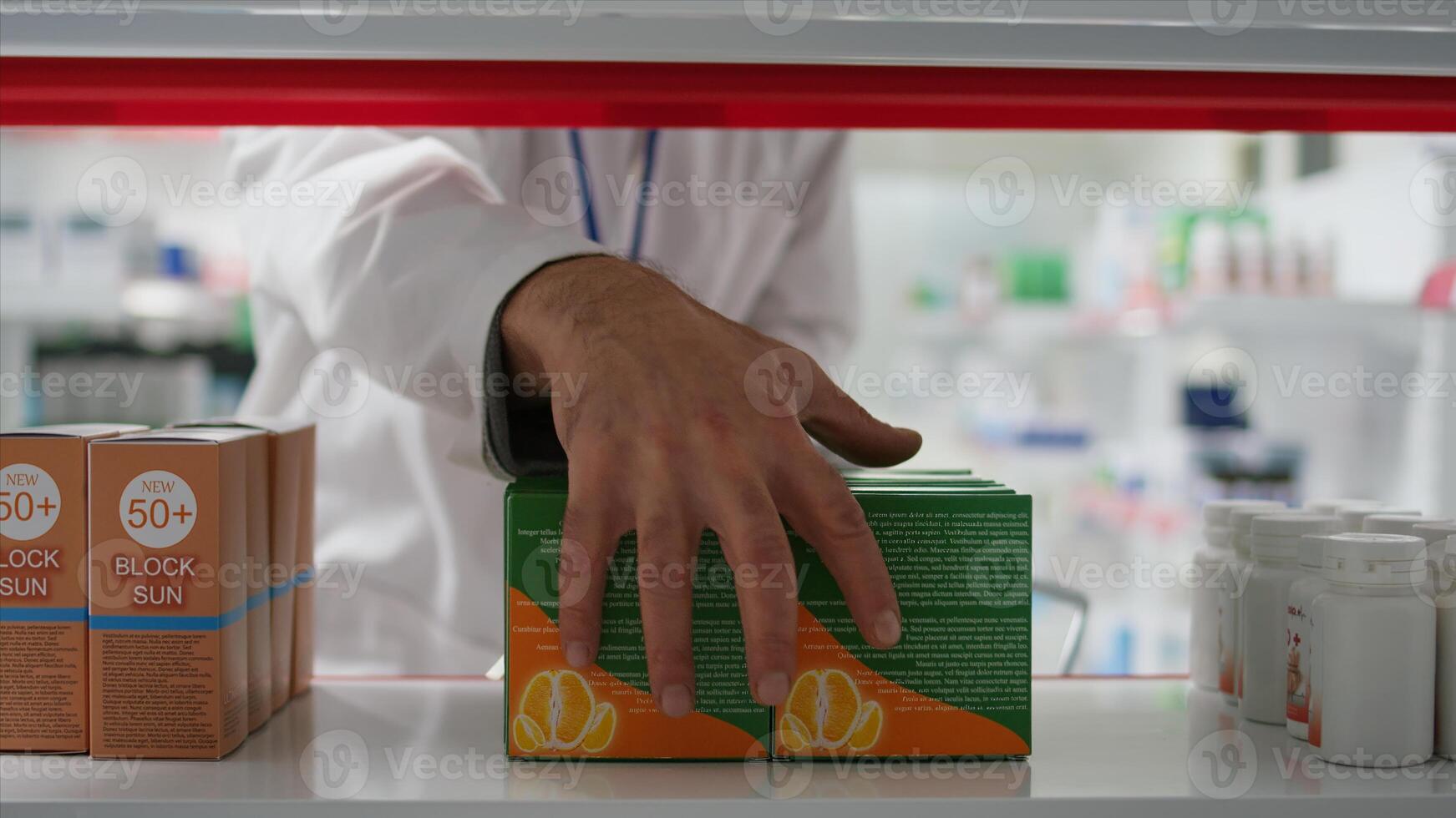 Retail employee emptying racks for products reorganization, taking all medicaments and vitamins in a basket. Seller working on restocking medical products and pharmaceutical supplies. Tripod shot. photo