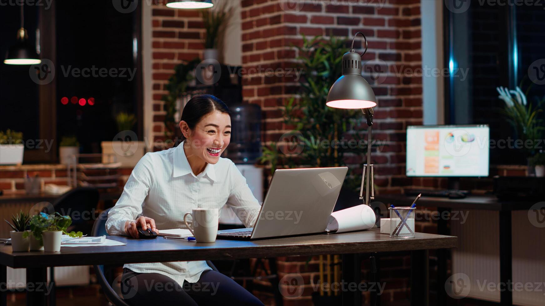 Joyous worker jumping around office from excitement after learning of upcoming promotion, rewarded for good results. Employee receiving amazing news, throwing hands in air in celebration, camera B photo