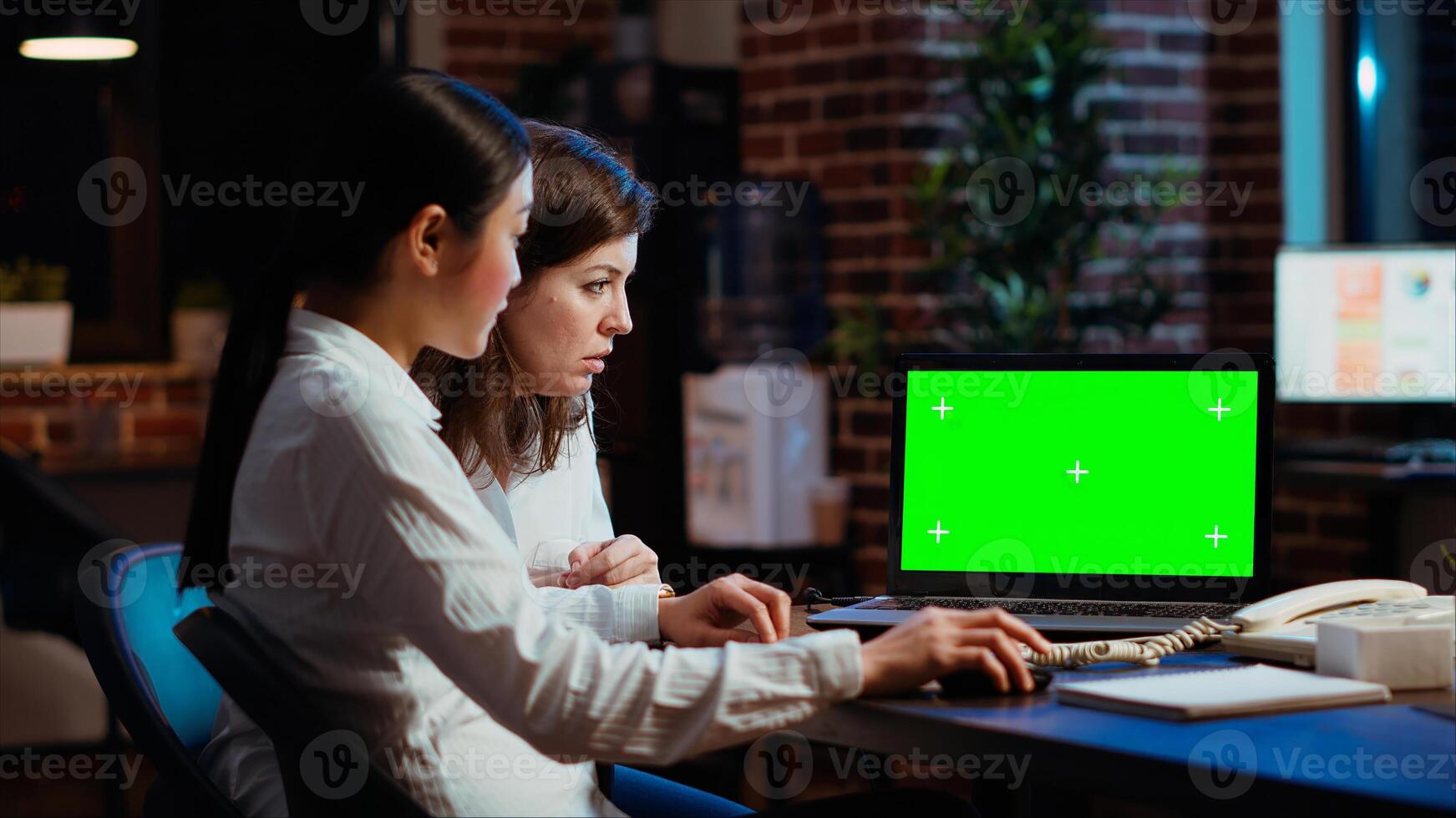 Manager and company financial advisor analyzing statistical graphs on green screen laptop. Management executive and worker comparing business revenue numbers on chroma key device photo