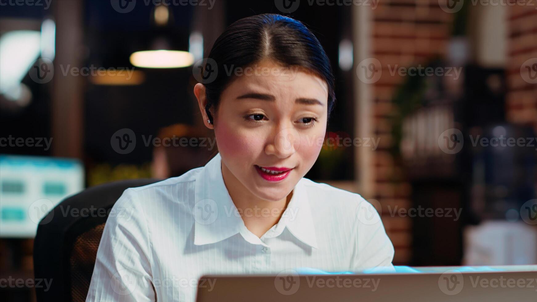 Happy businesswoman talking with coworkers during company meeting on internet videocall in office, close up shot. Worker speaking in remote videoconference telework call, collaborating on project photo
