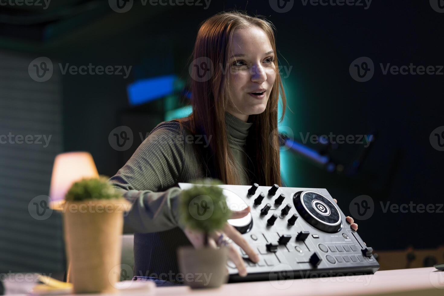Content creator doing giveaway for online channel subscribers, offering DJ controller device to most loyal fan. Media star happy to gift viewers professional sound mixer, doing contest photo