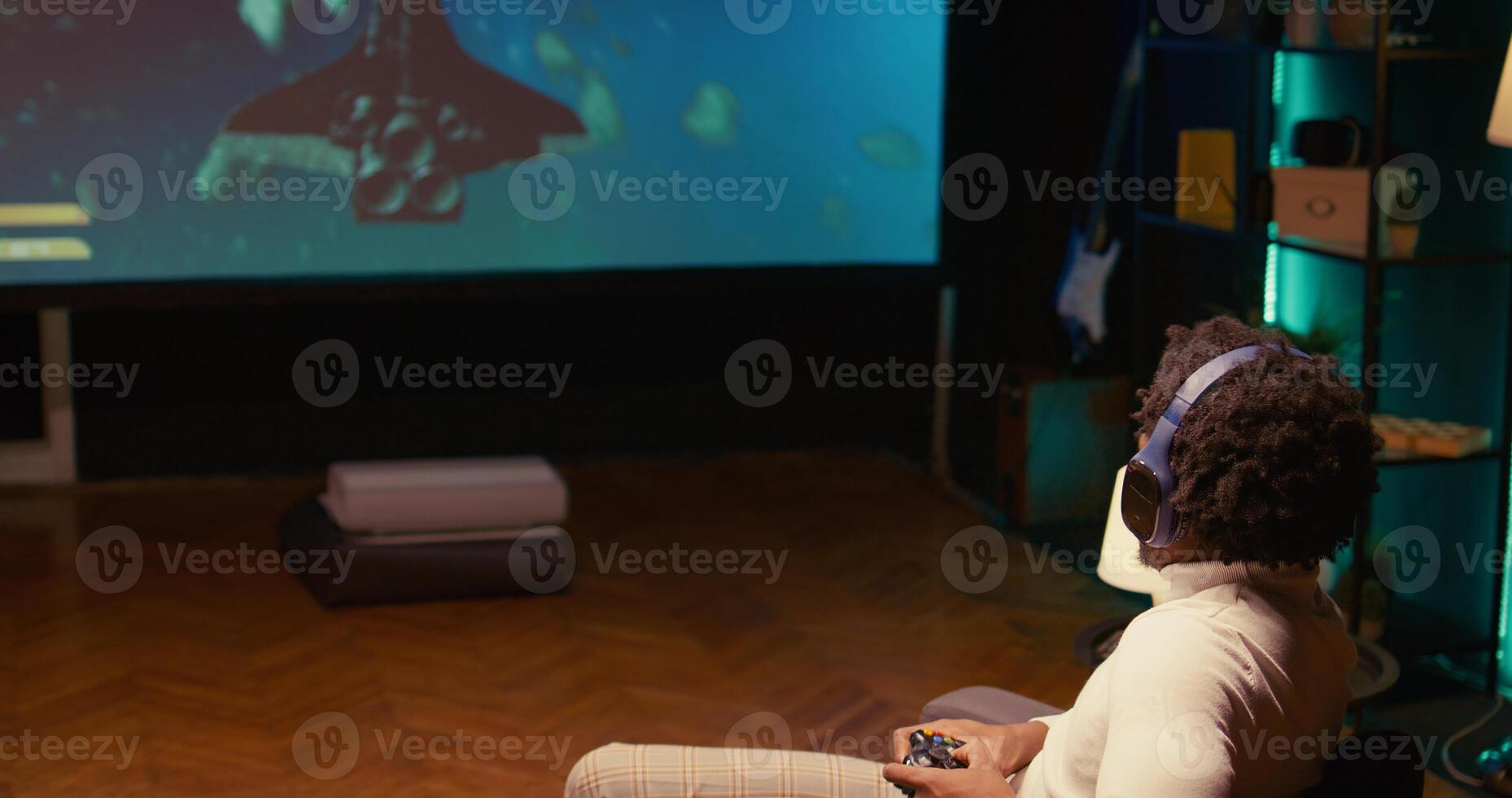 African american gamer plays game with spaceship shooting laser streams using crosshair overlay to hit targets. Ray tracing graphics and high FPS scifi videogame displayed on TV screen, dolly in shot photo