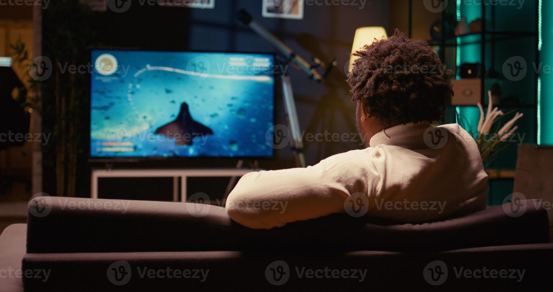 BIPOC gamer plays game with spaceship shooting laser streams using crosshair overlay to hit enemies. Ray tracing graphics and high FPS scifi videogame displayed on television set, zoom in shot photo