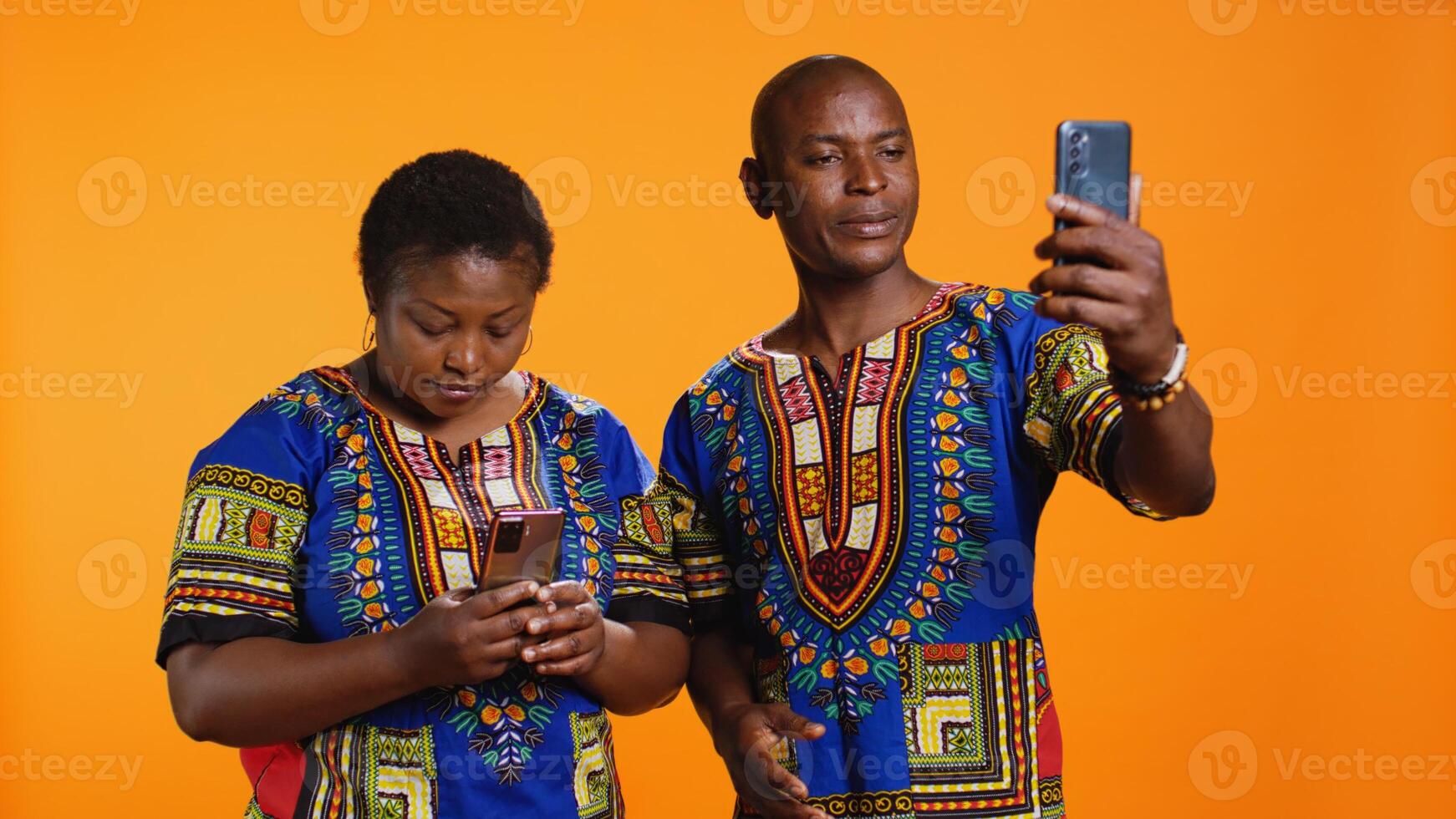 Married man and woman waving hi on web videocall network, using internet connection and link to speak with family members. Young couple holding mobile phone to chat to people. photo