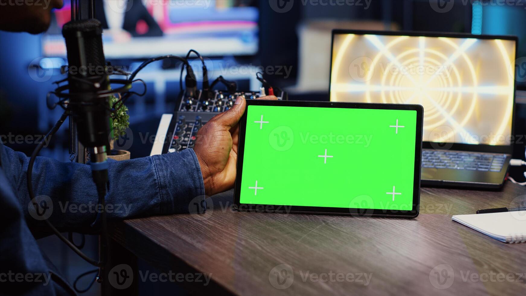 Man invited to podcast watching internet clips on green screen tablet with host in living room studio. Guest and presenter reacting to videos on mockup device during online comedy show, close up photo